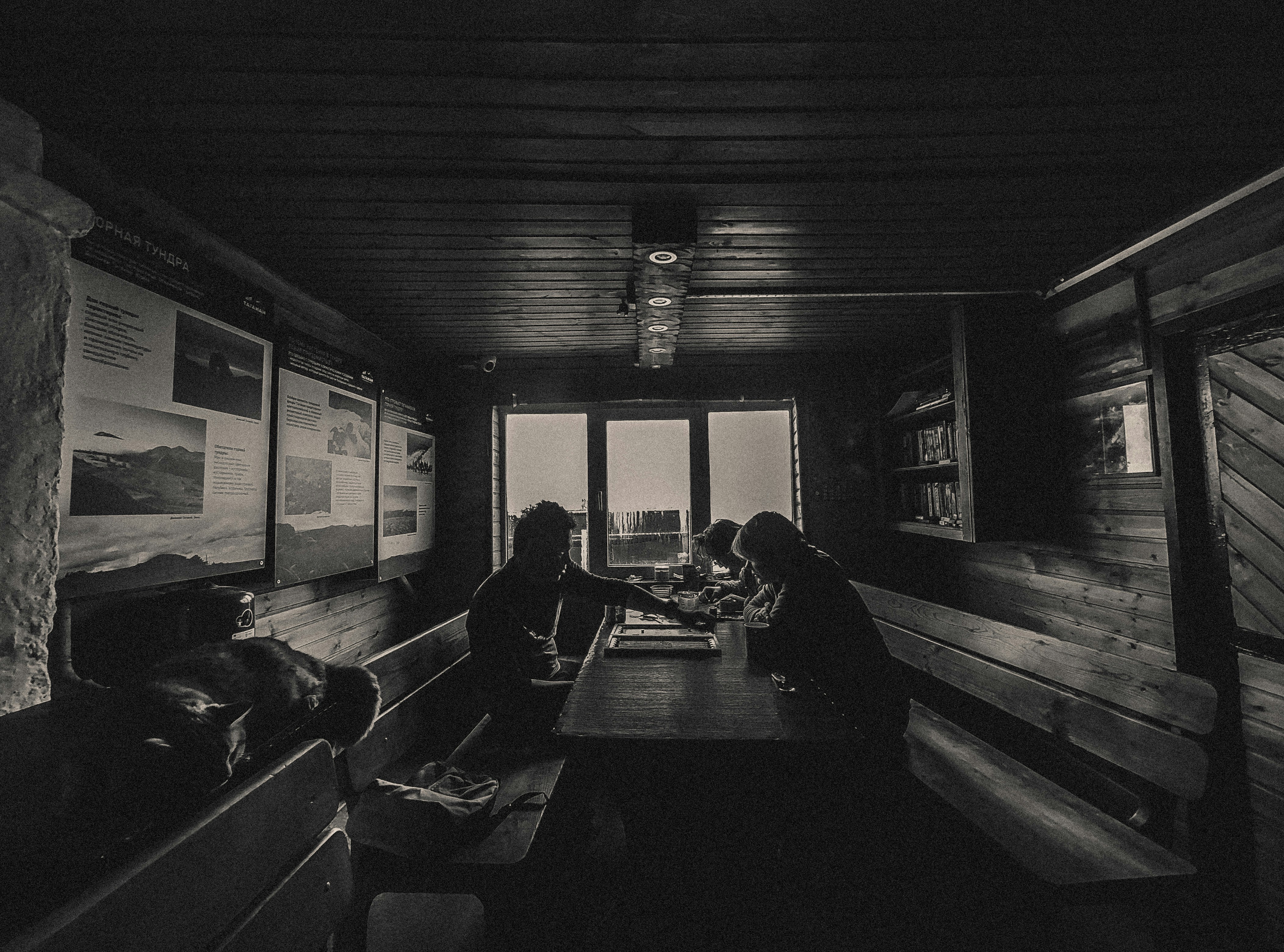 People sitting at a table in a rustic cabin.