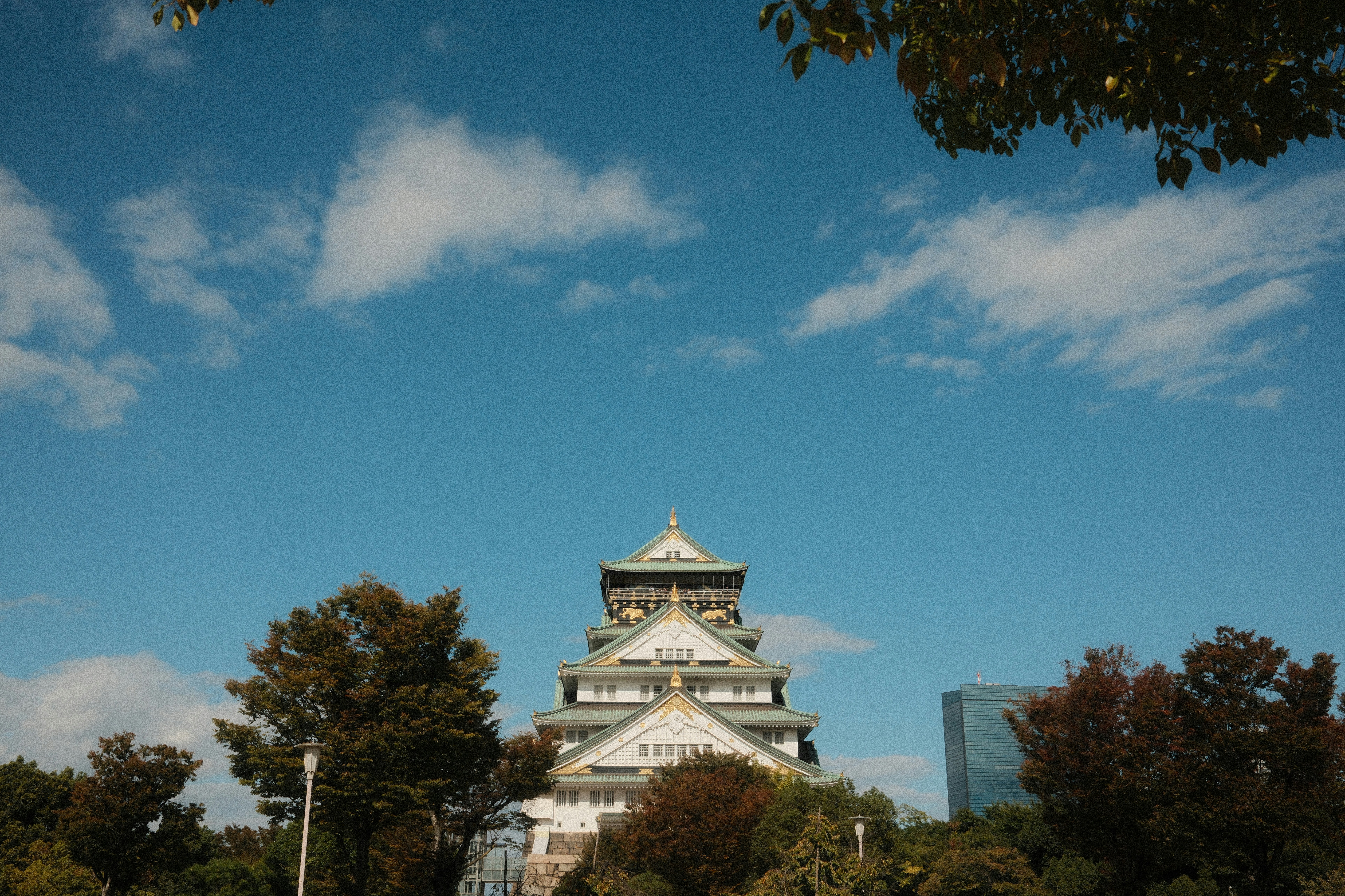 Osaka castle against a bright blue sky