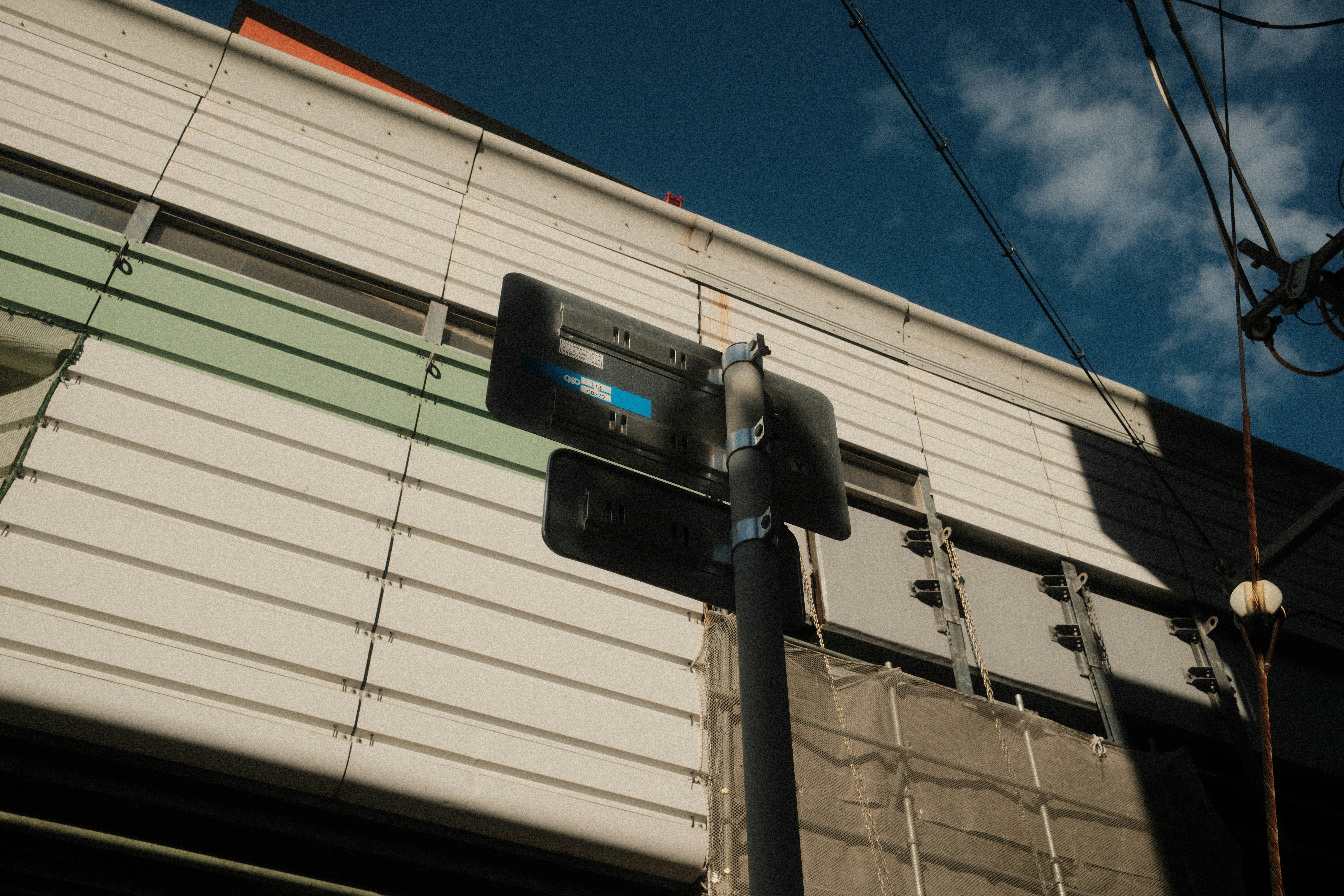 Street sign against a building and sky