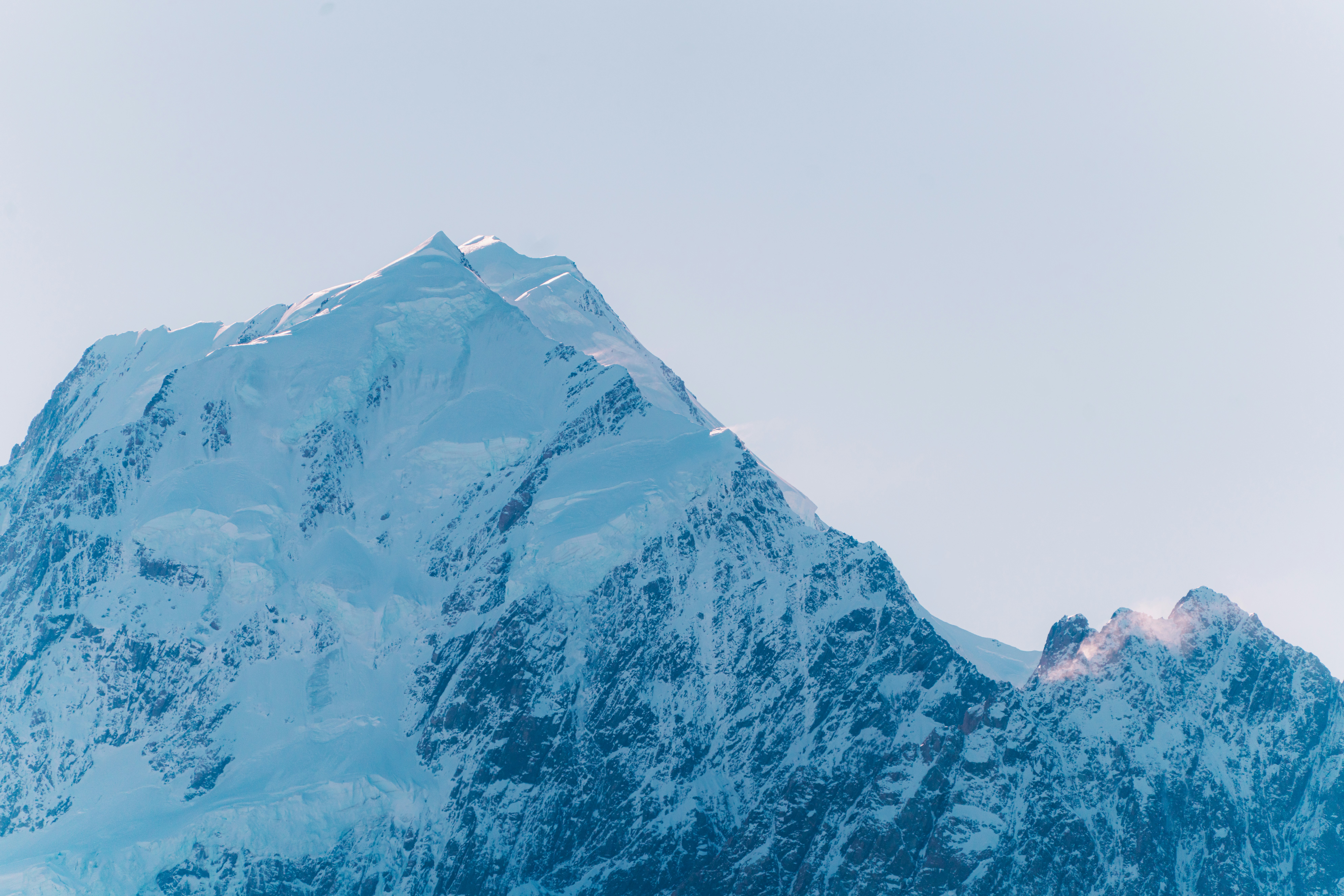 Snow-covered mountain peak against a clear sky