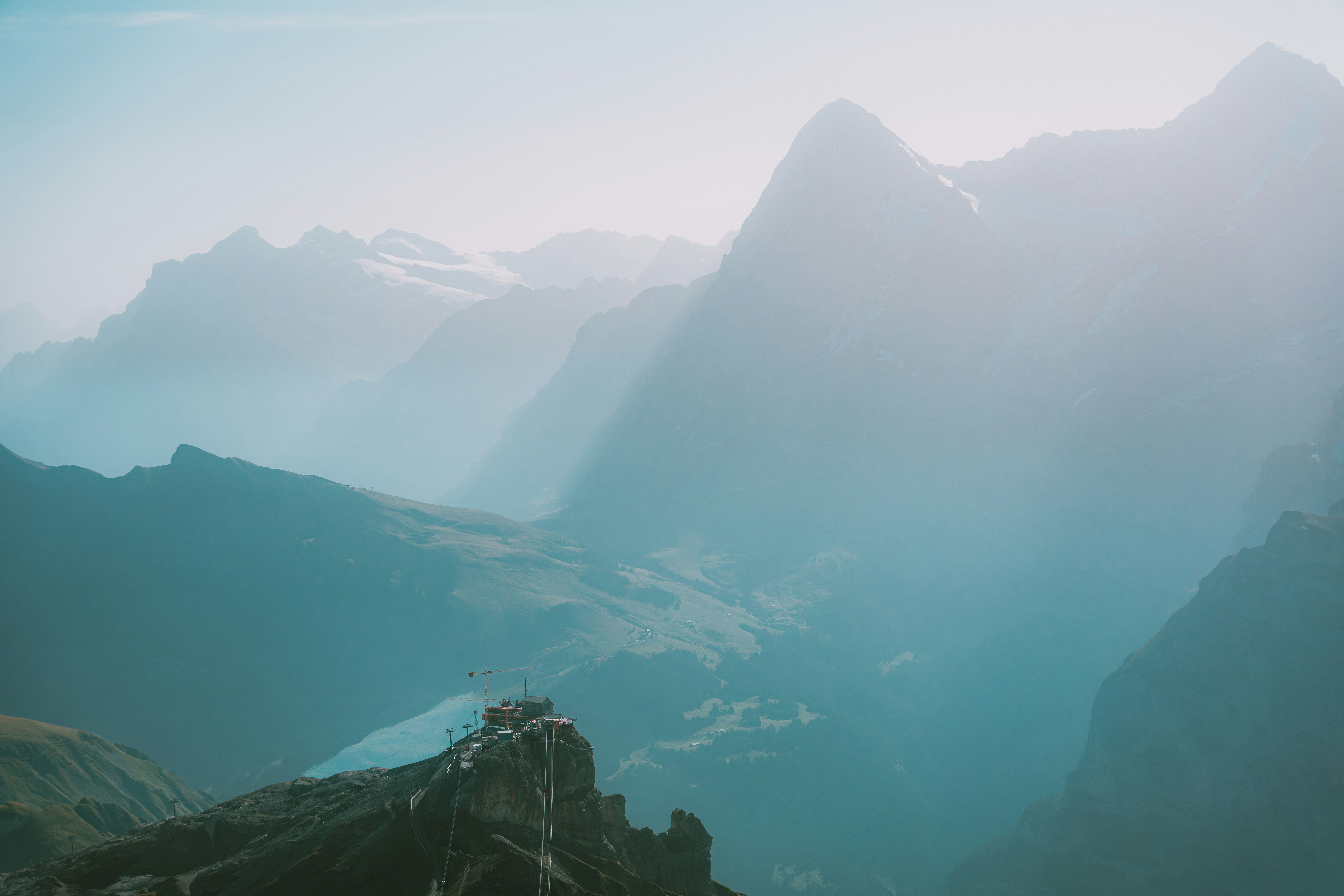 Misty mountain range with a clear sky above.