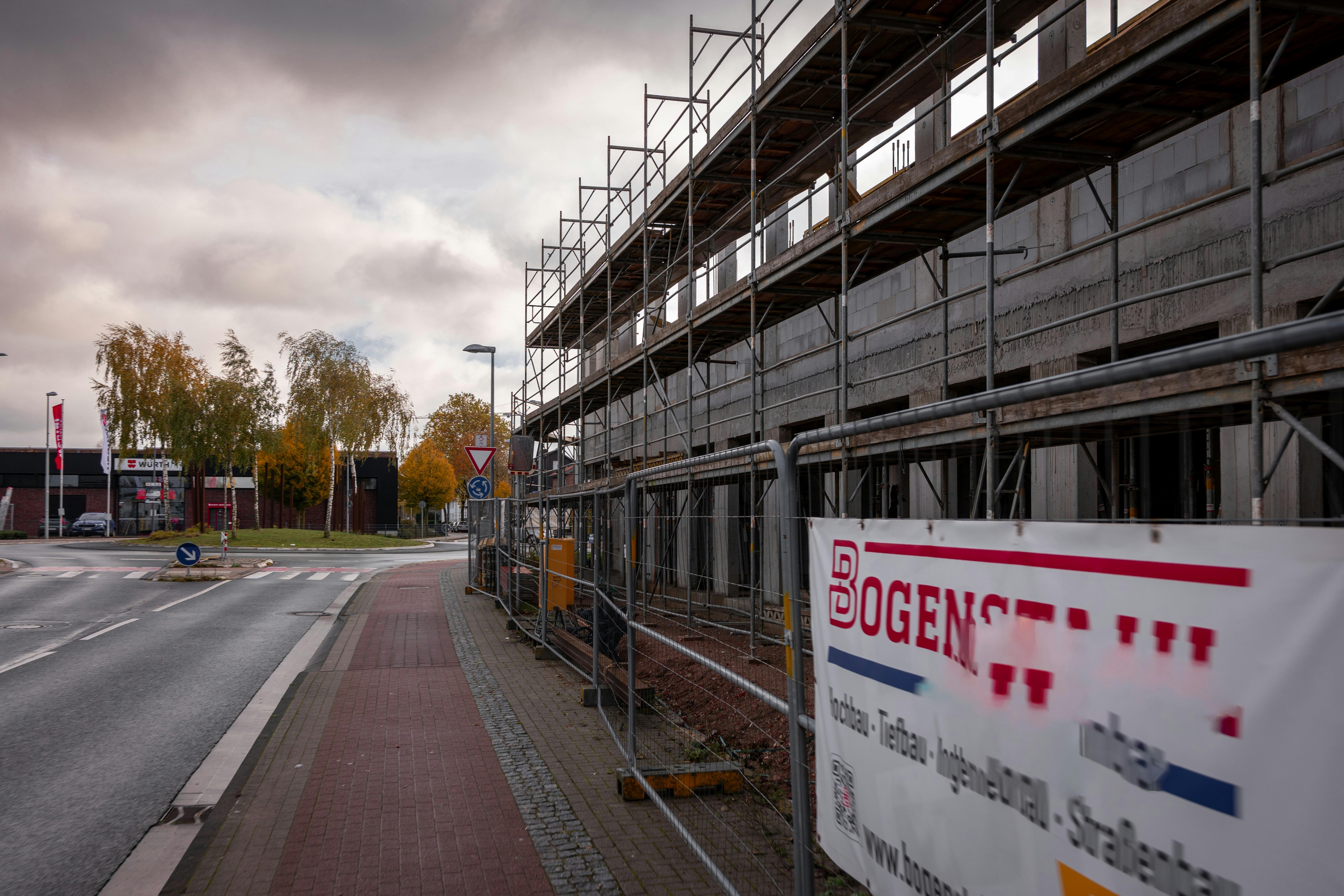 Building under construction with scaffolding and signage