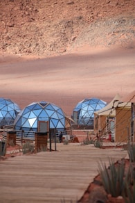 Geodesic domes and tents in a desert landscape.