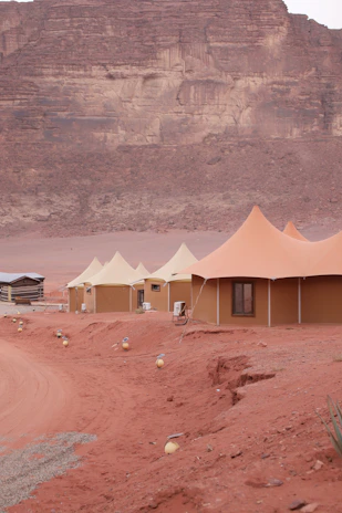 Desert tents set up in a rocky, arid landscape.