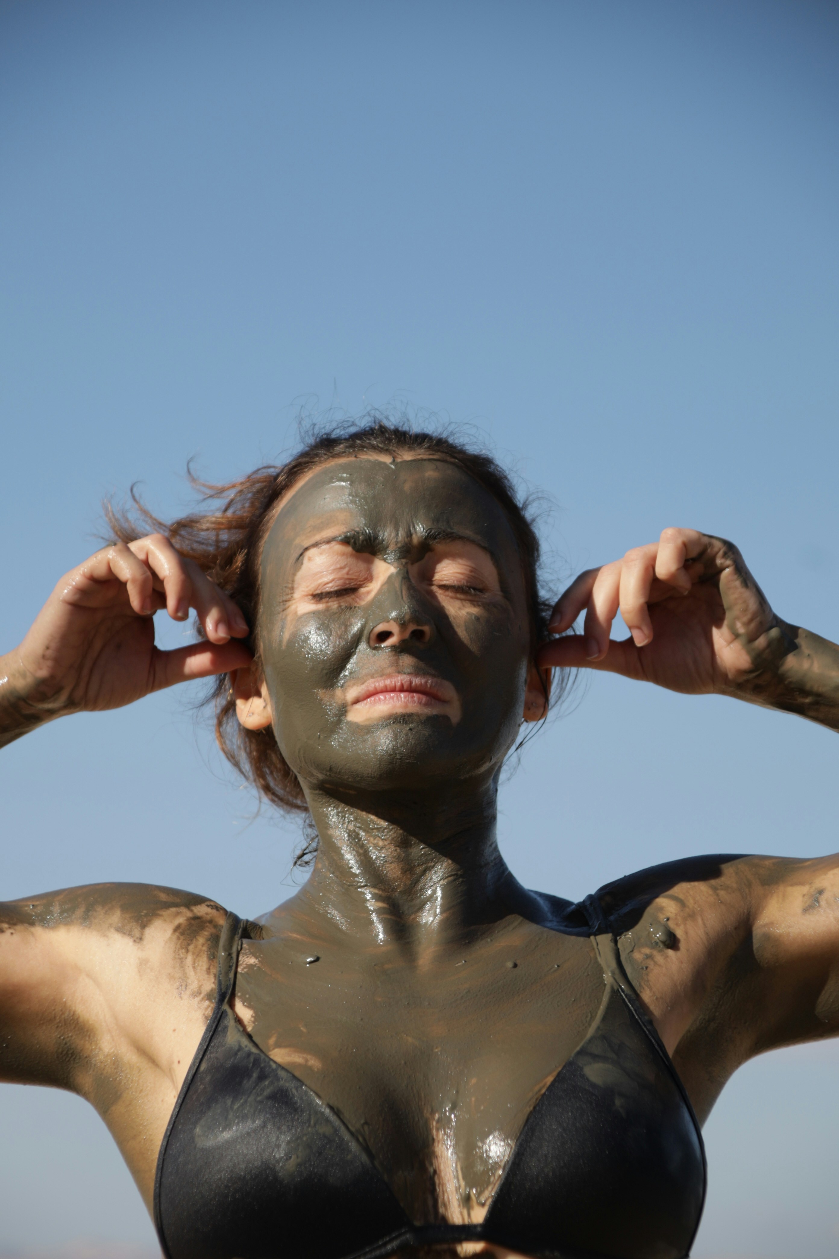 Woman with mud mask and closed eyes