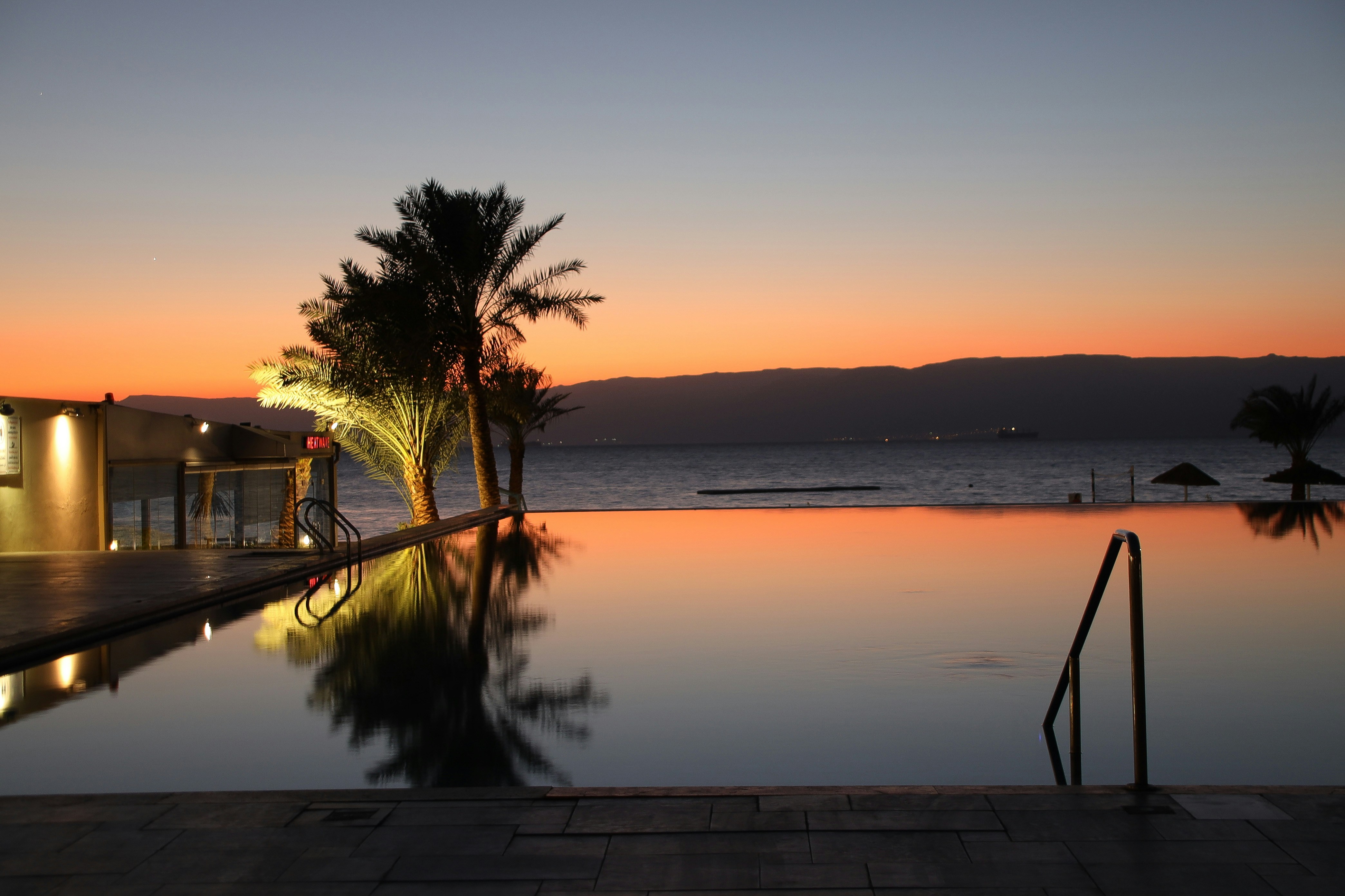 Infinity pool overlooking the ocean at sunset