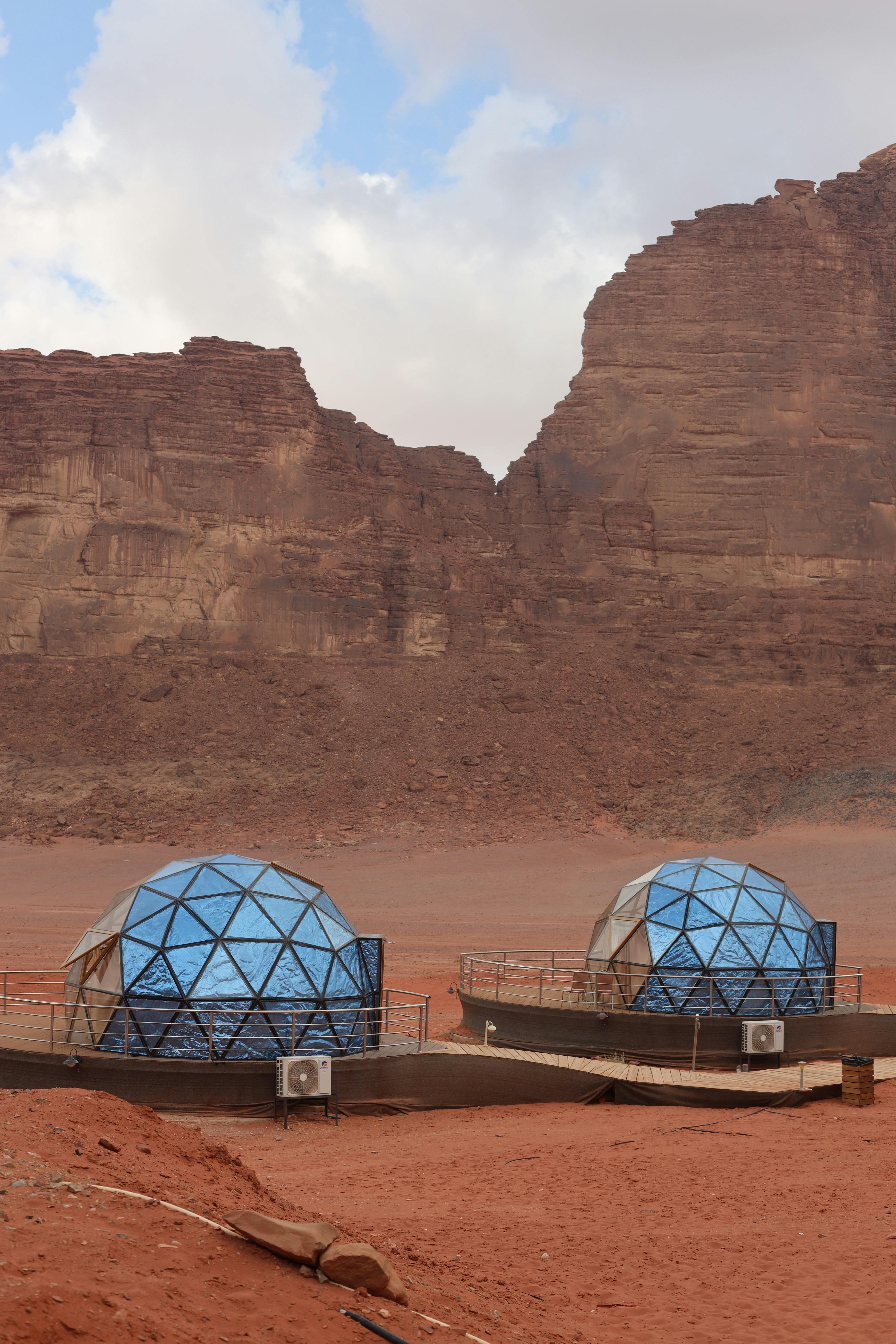 Two geodesic domes in a desert landscape