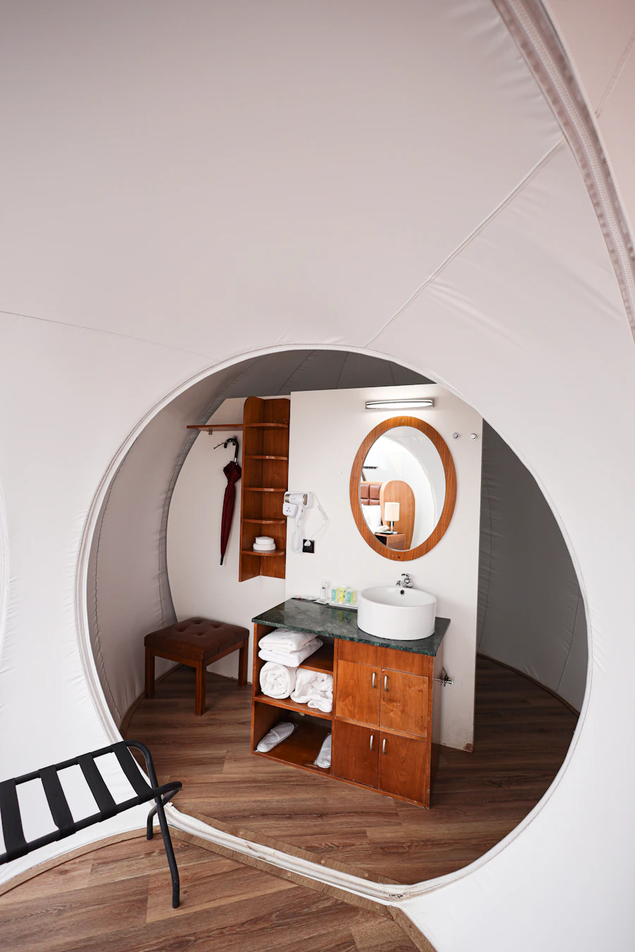 Hotel bathroom vanity cabinet with open shelf and towels
