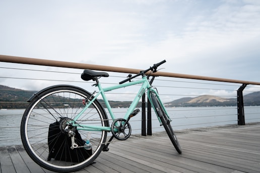 Light blue bicycle resting on a wooden pier on Rab island