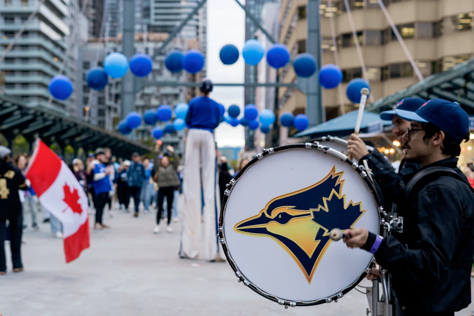 People celebrate with a drum and balloons