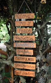 Wooden signs with virtues hanging on a tree