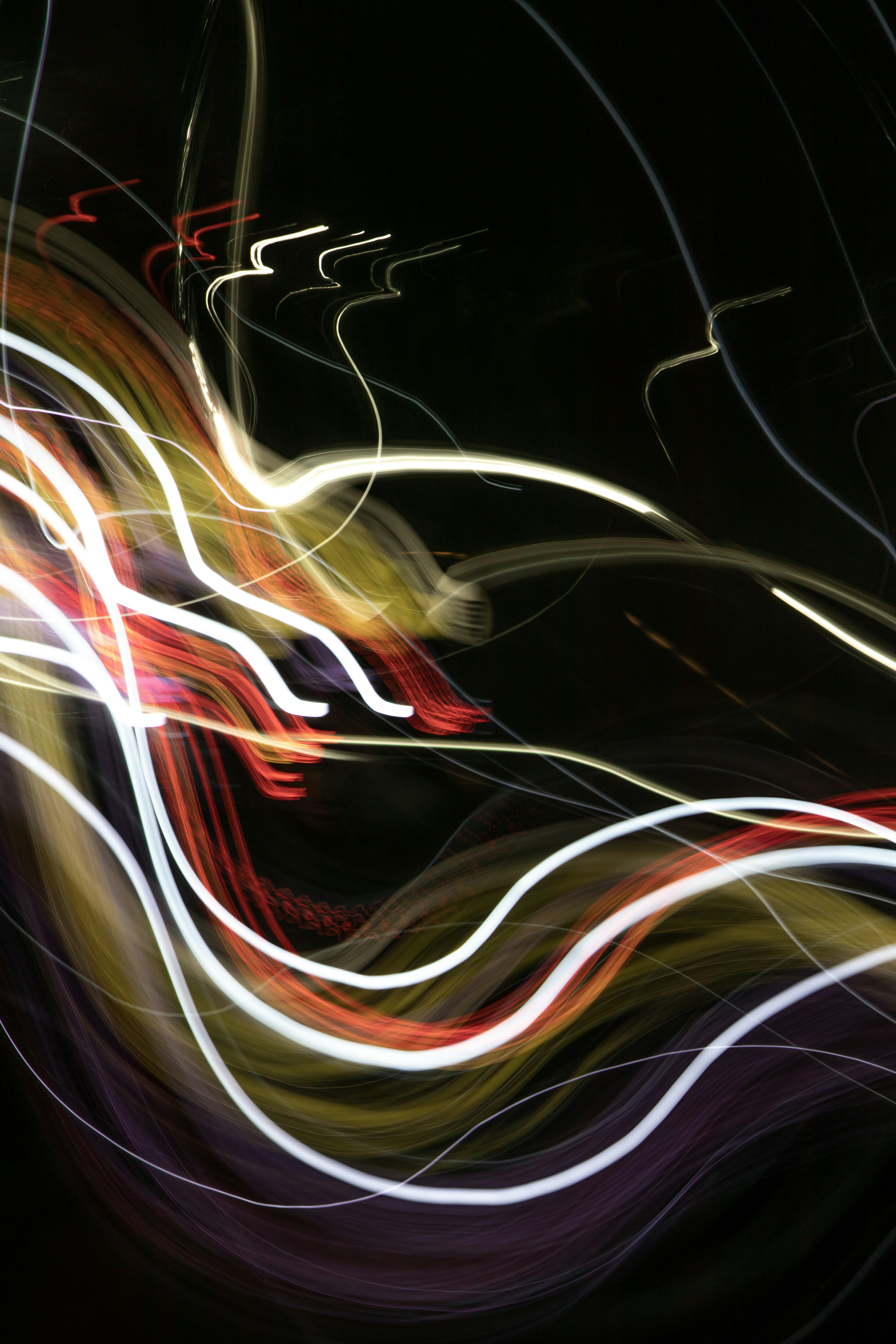 Abstract streaks of colorful light trails at night.