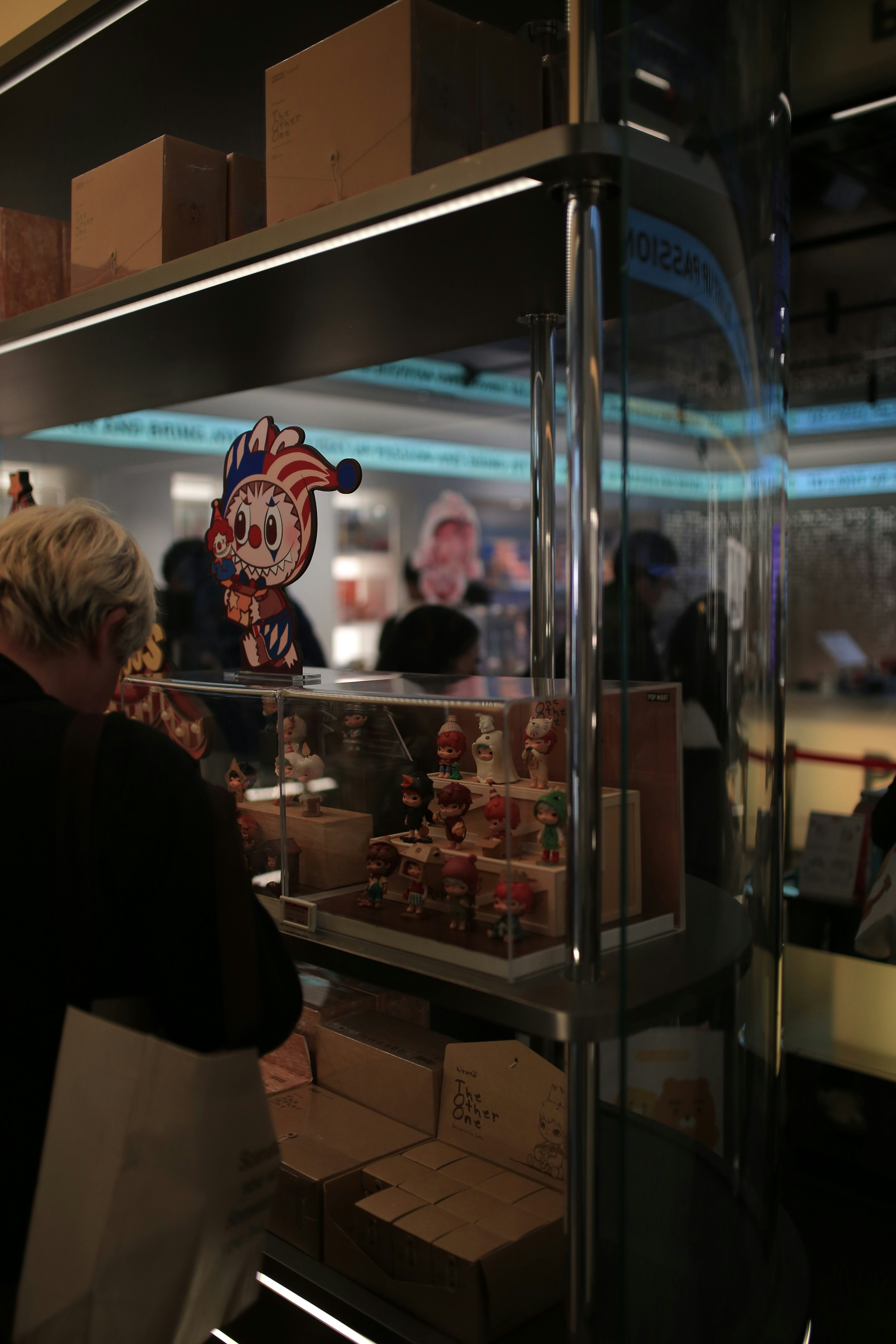 A person looking at a display of small figures.