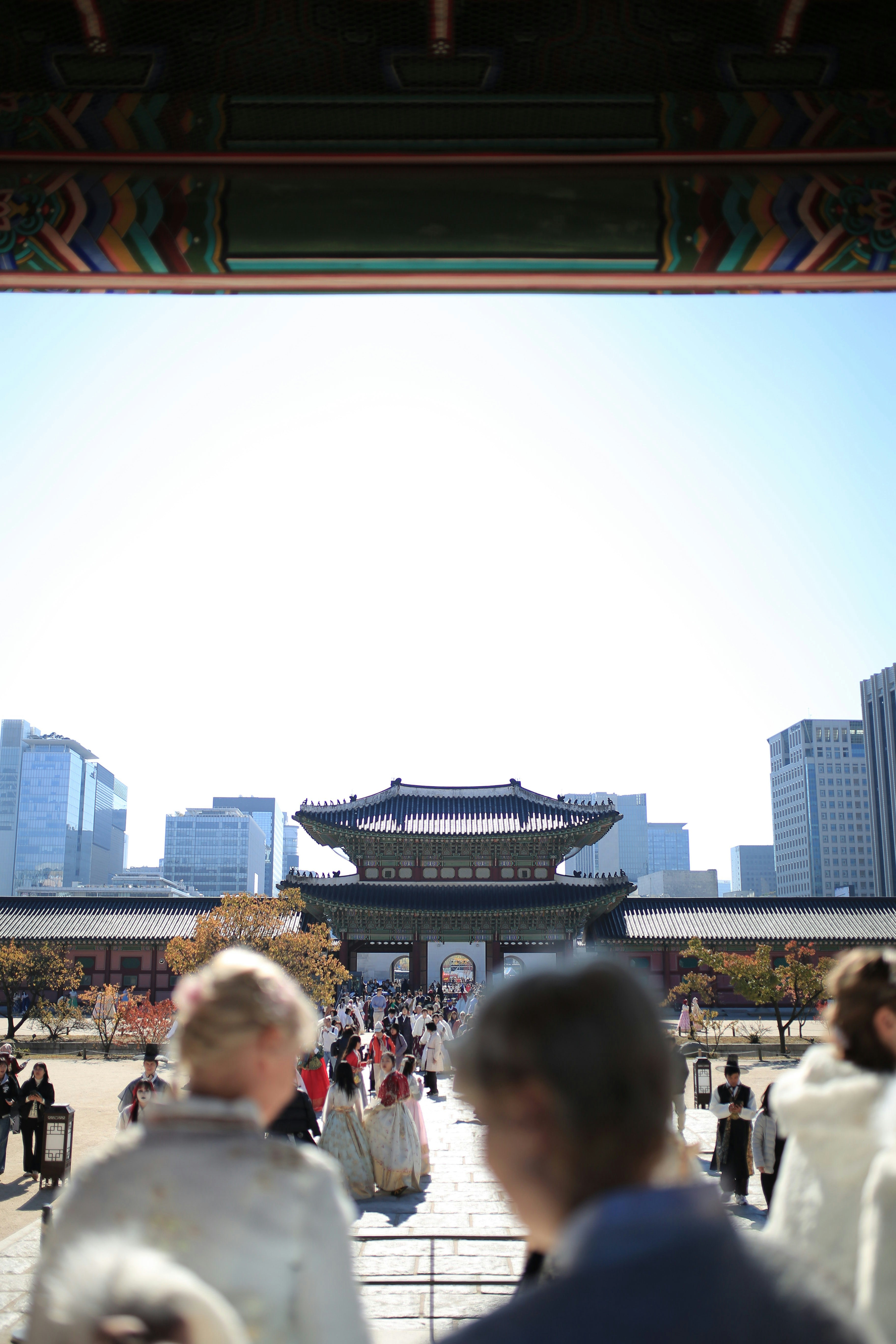 People in traditional korean clothing at gyeongbokgung palace.