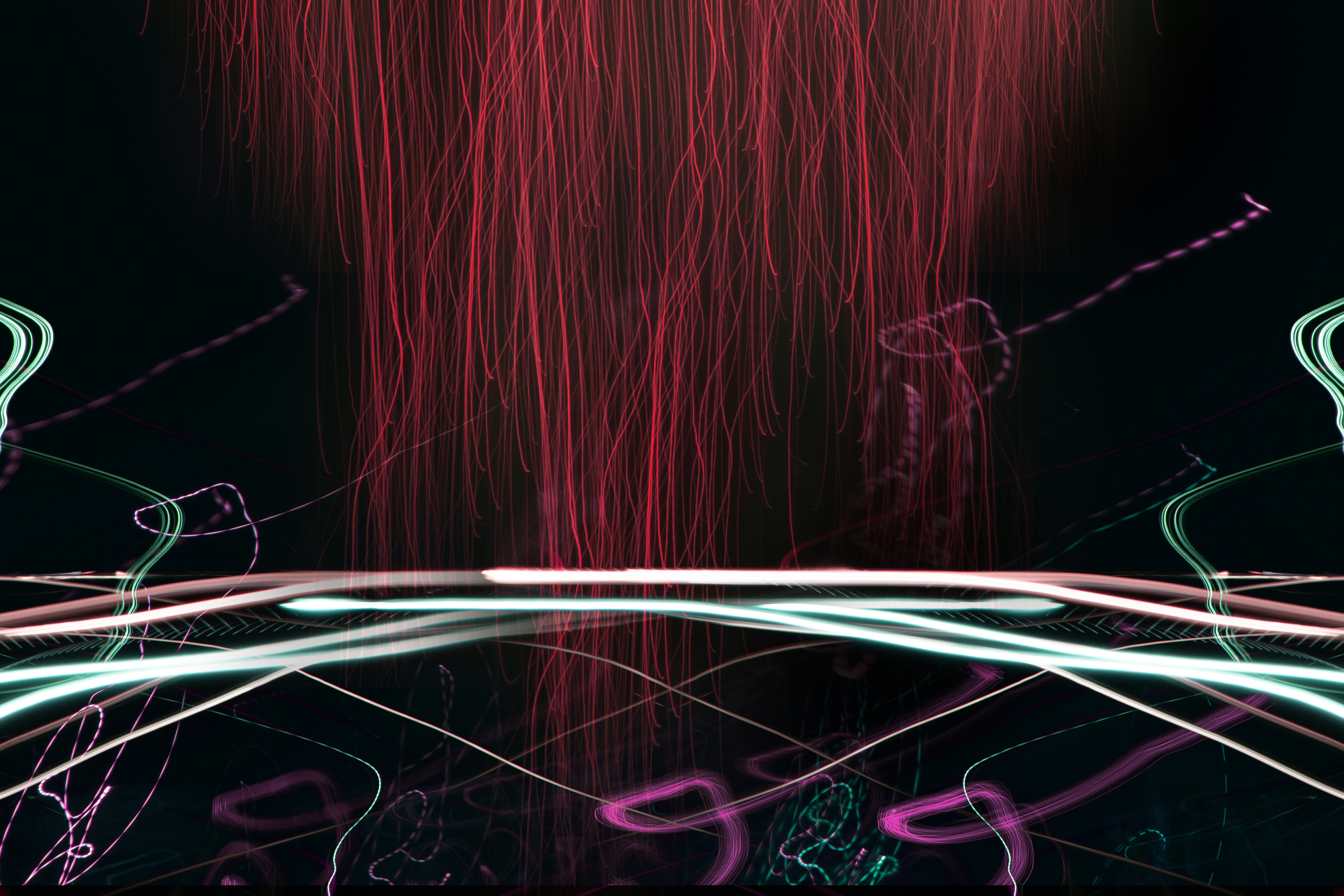 Abstract red and white light trails on black background