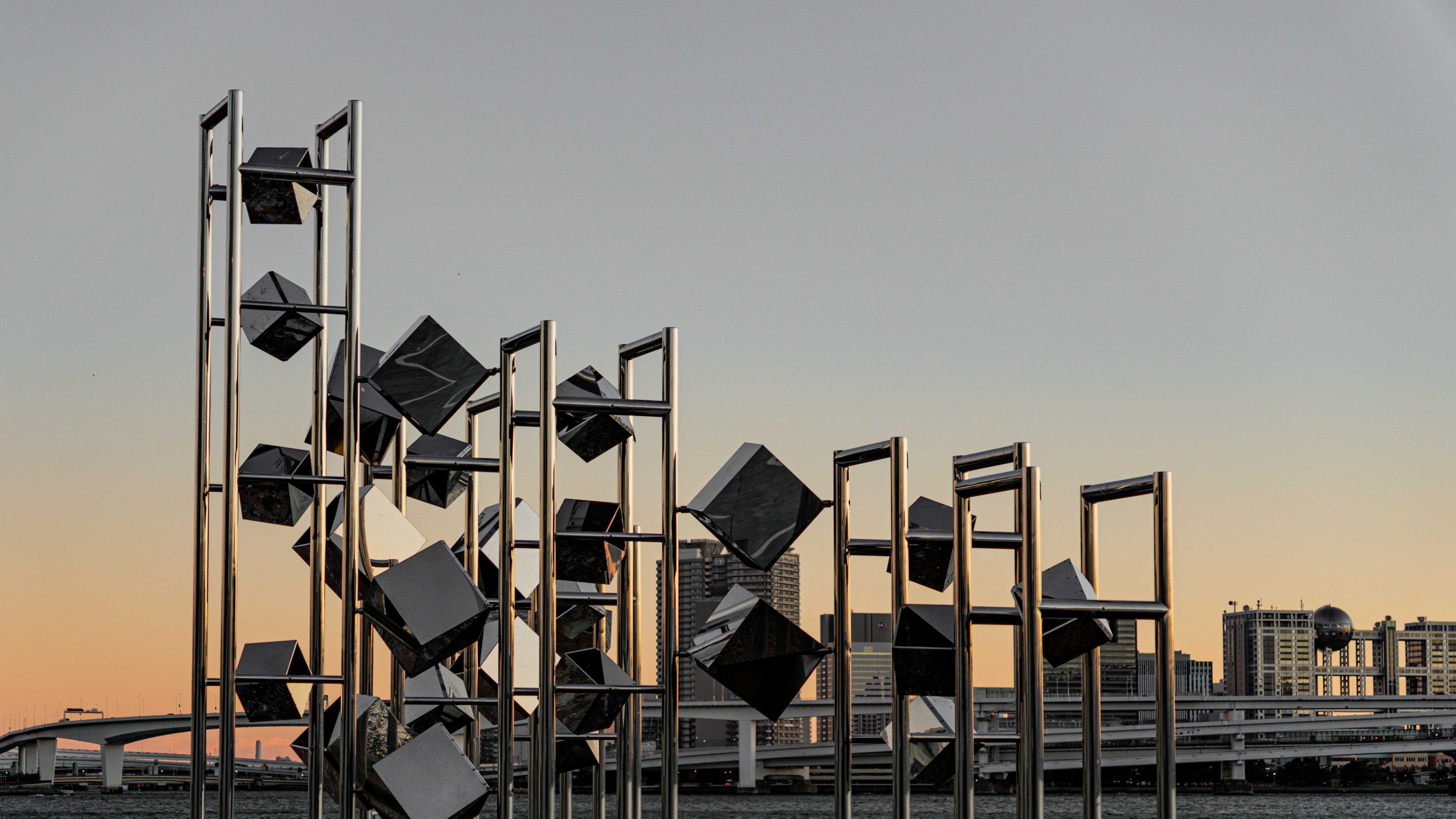 Modern sculpture with cubic elements against sky