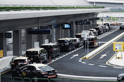 Taxis lined up at a modern transportation hub.