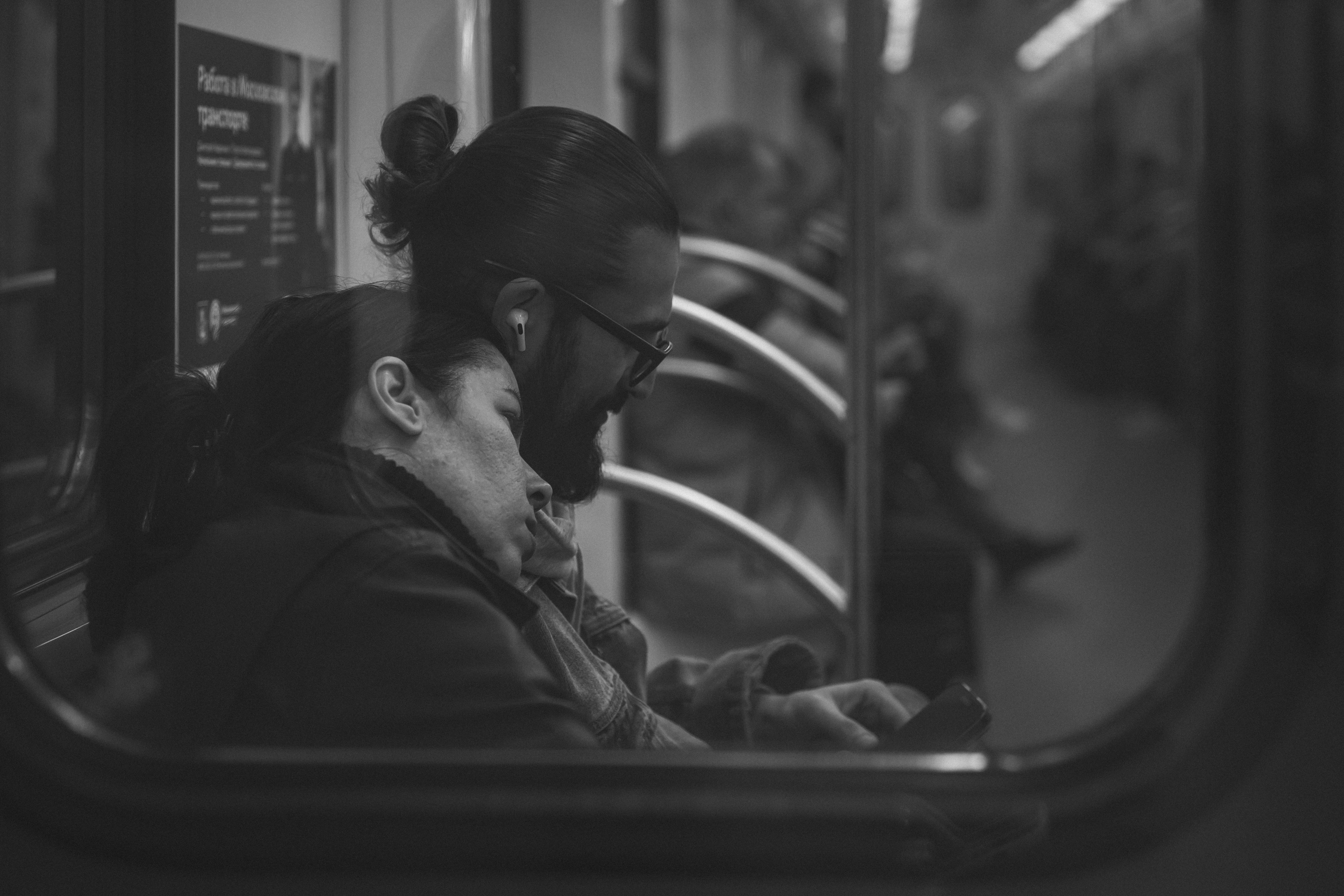 Couple sleeping on a subway train