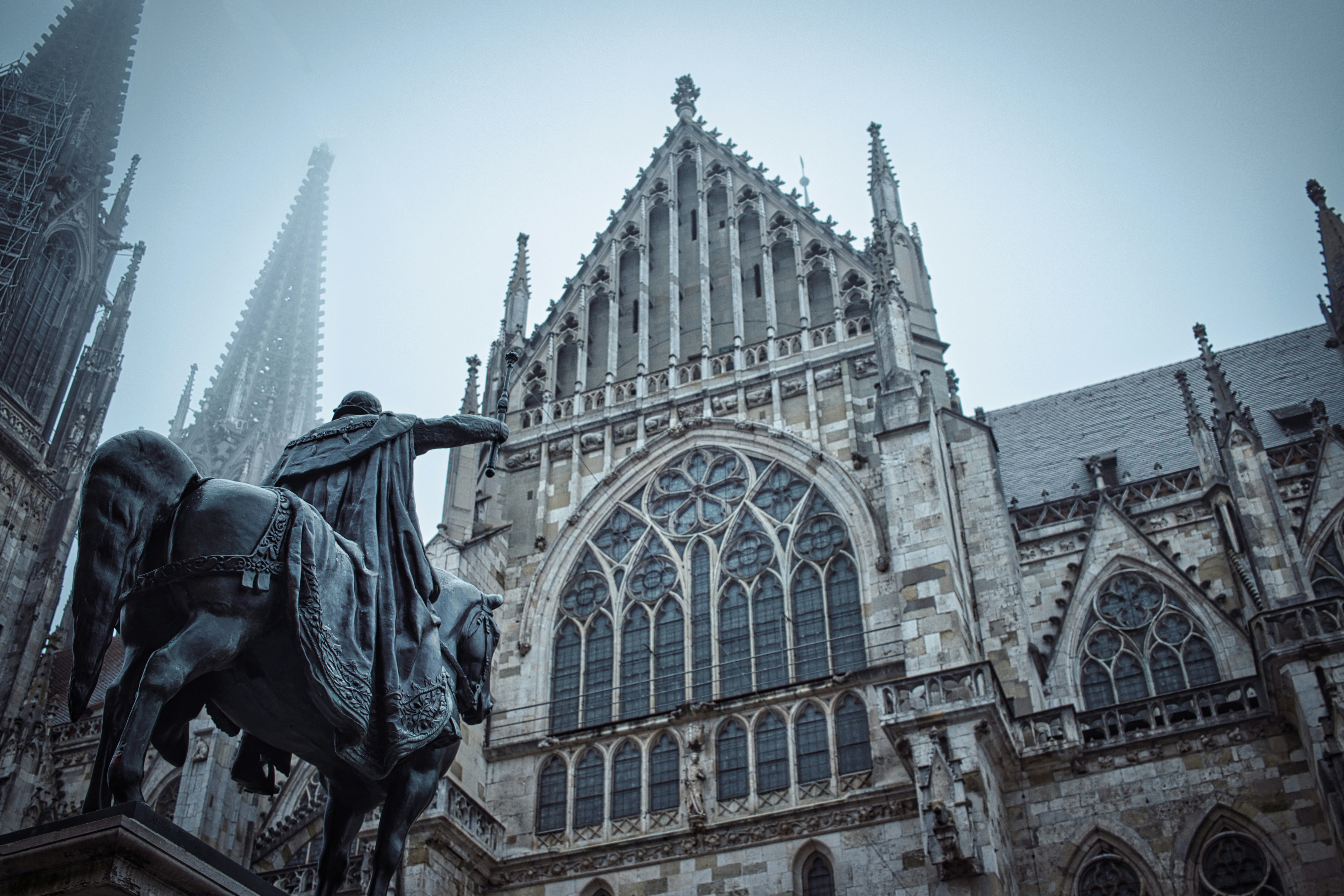 Equestrian statue in front of a gothic cathedral