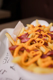French fries topped with melted cheese and sausage.
