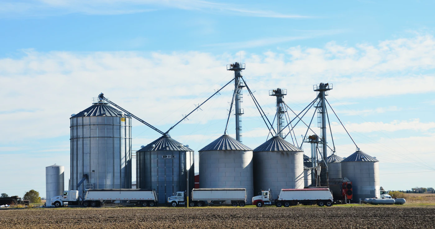 Industrial grain silos with trucks loading