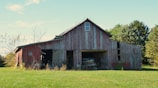 Old red barn in a grassy field
