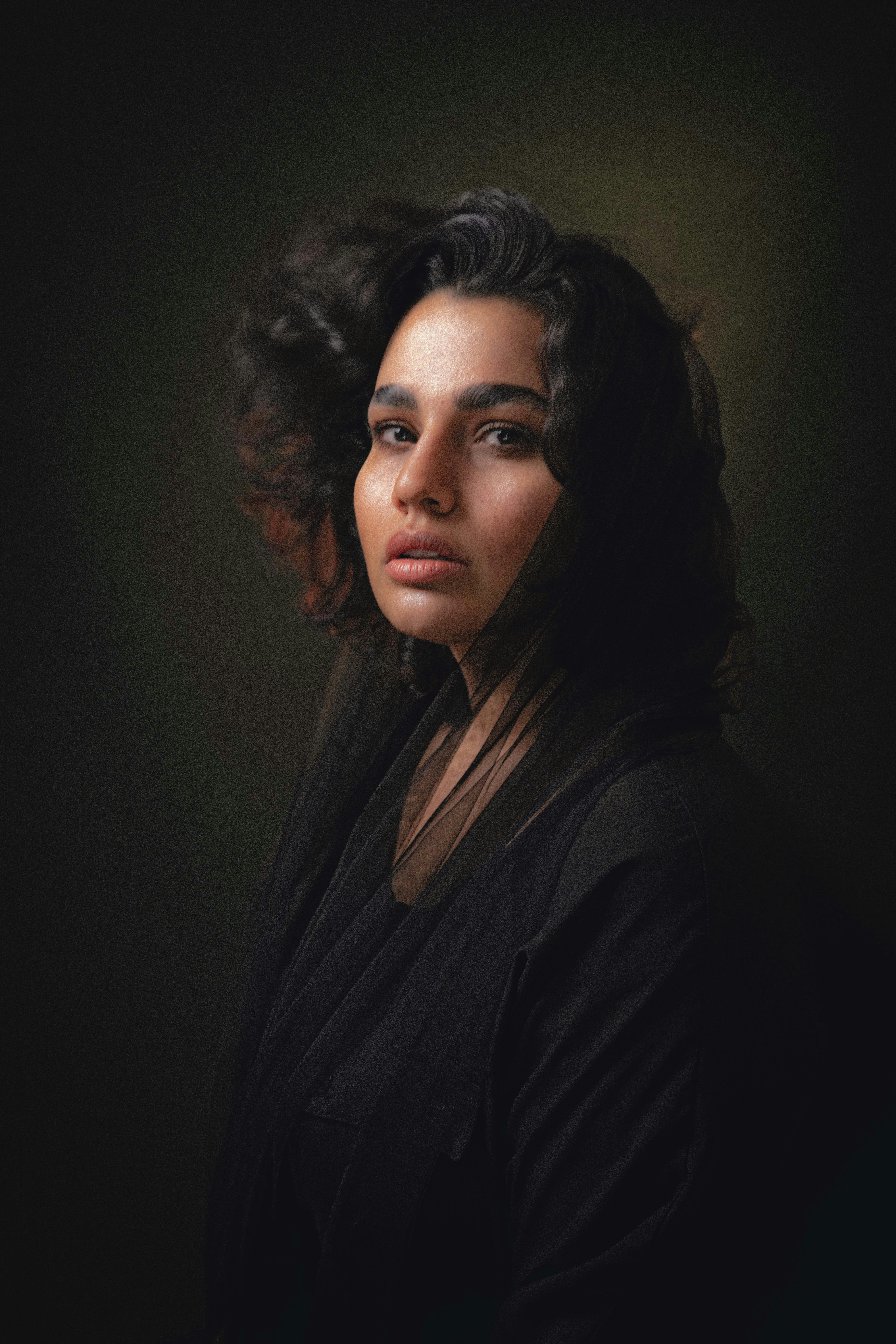 A woman with dark hair looking at the camera.