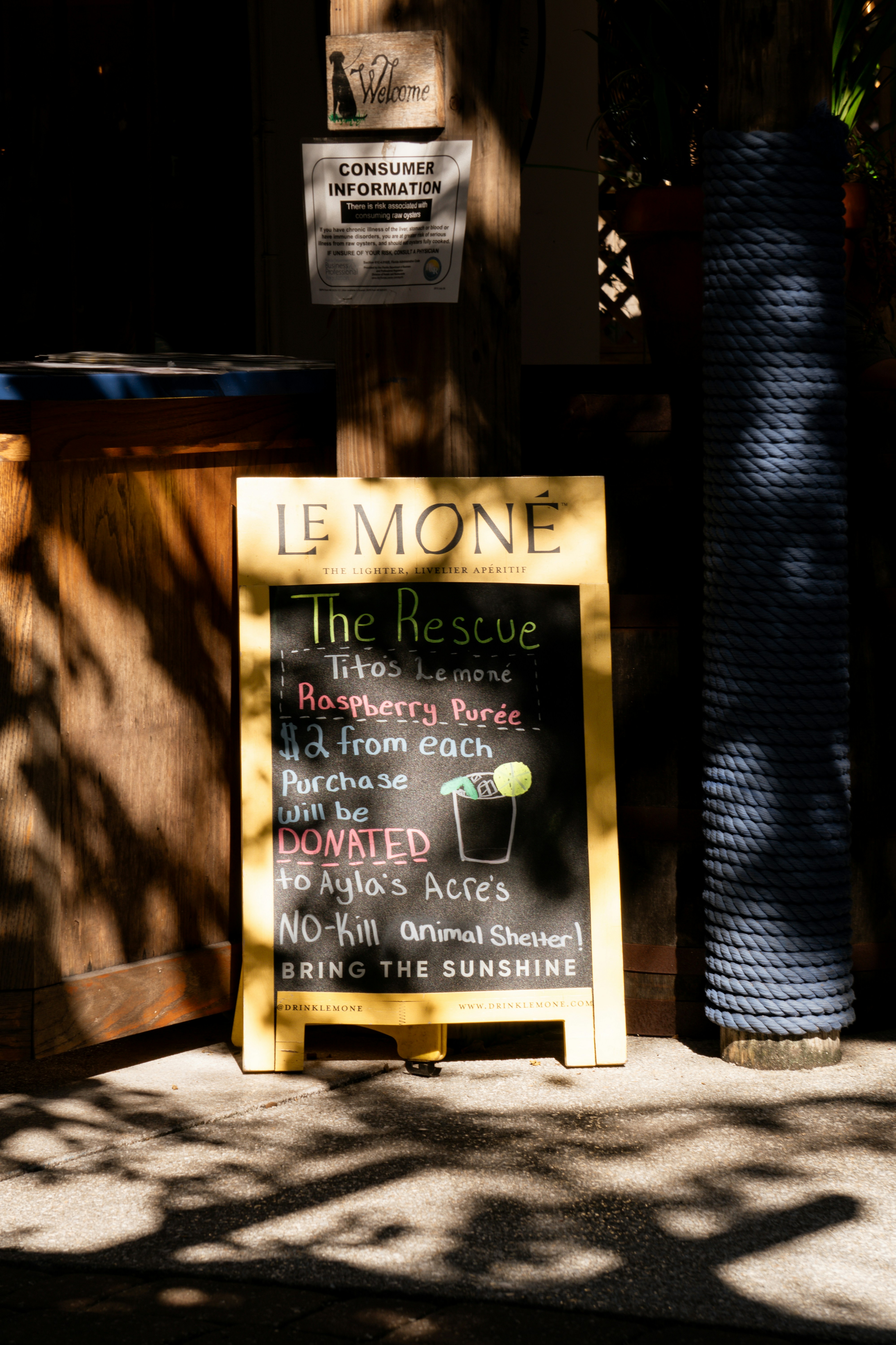 Chalkboard sign advertising a drink for animal rescue.
