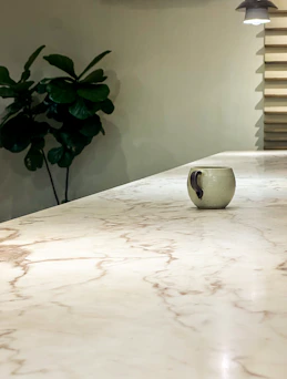 A single mug sits on a marble countertop.