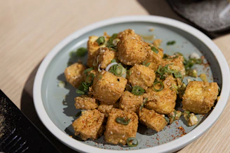 Crispy fried tofu cubes sprinkled with green onions