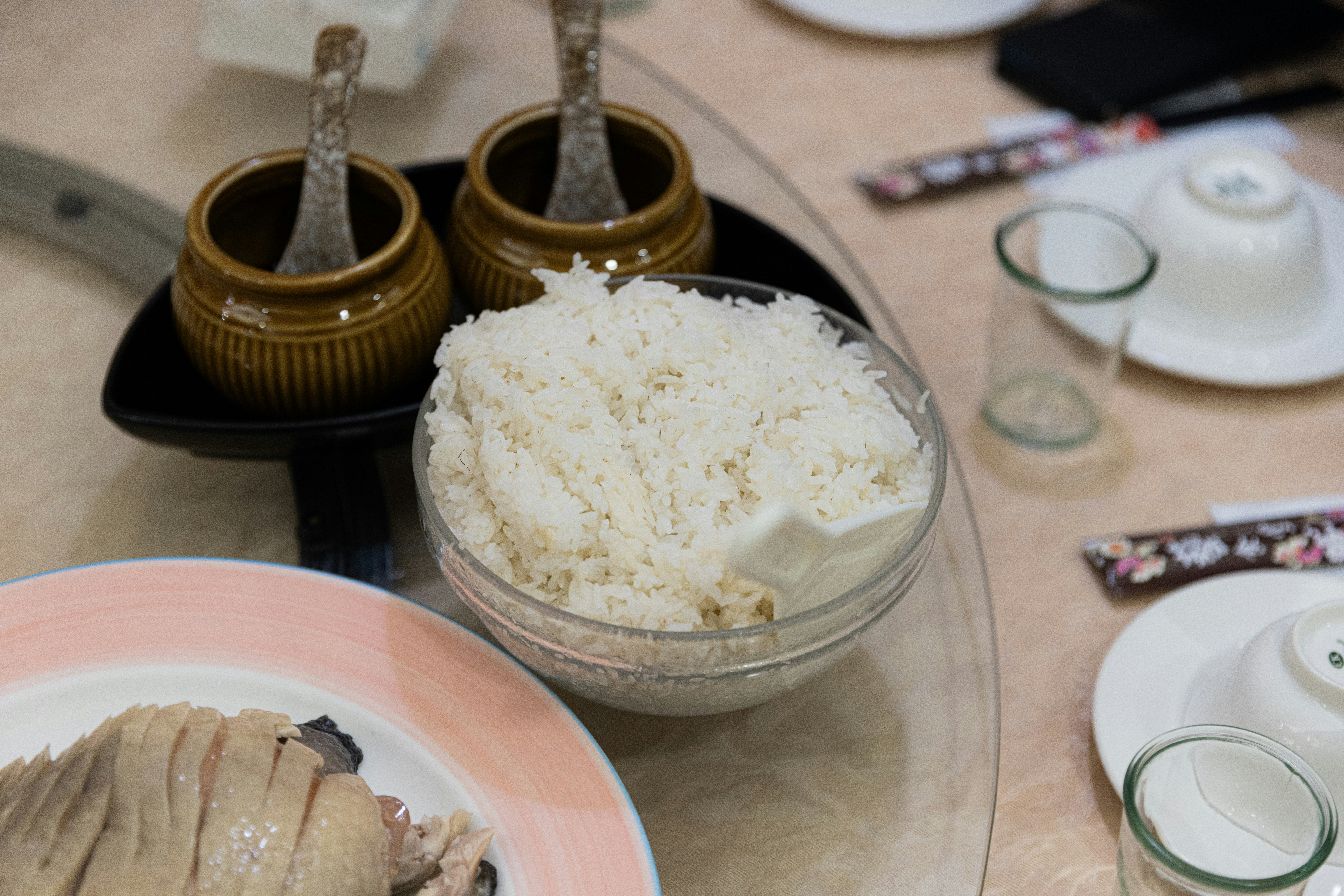 Bowl of white rice with condiments and food