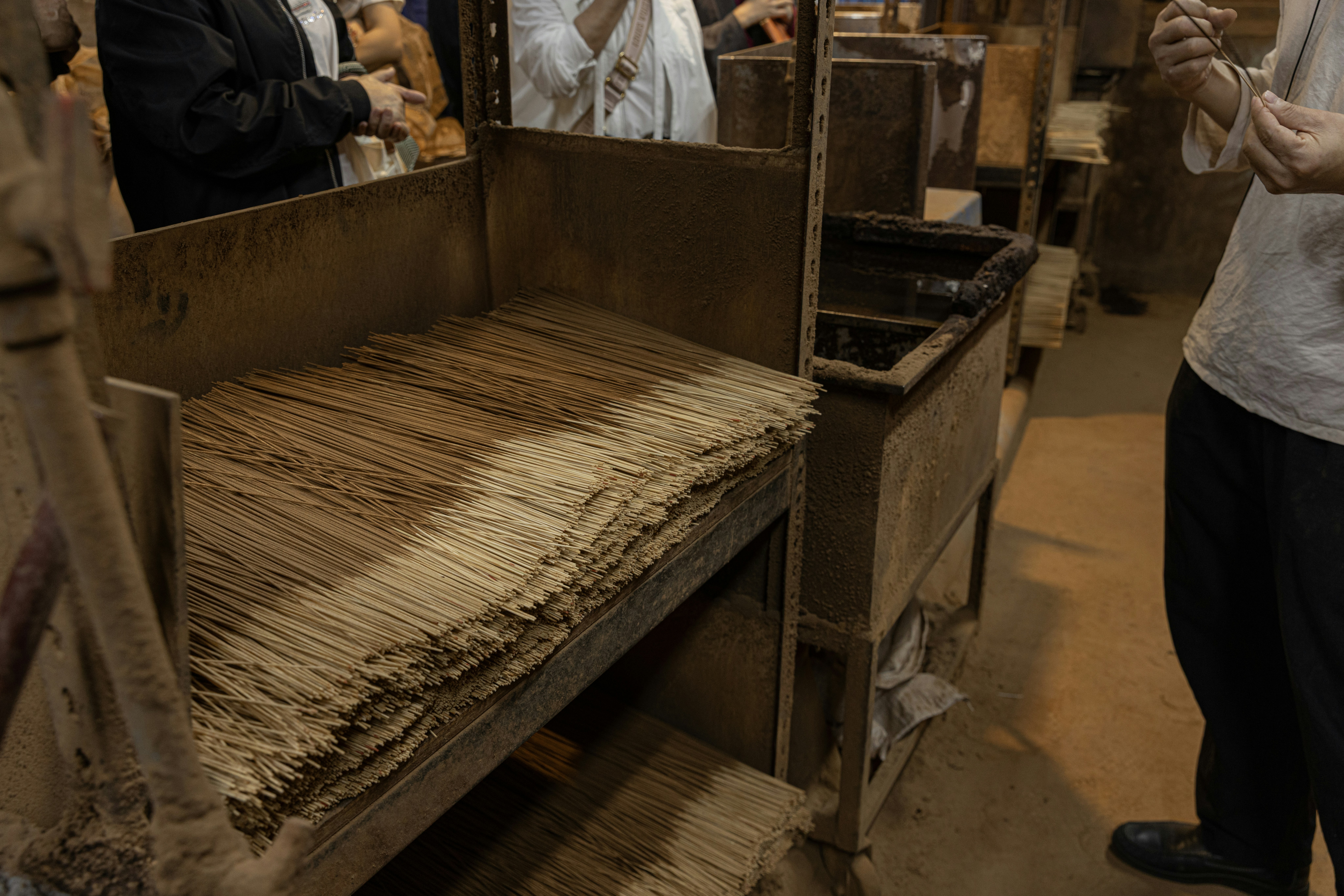 Stacks of dried reeds on a wooden shelf