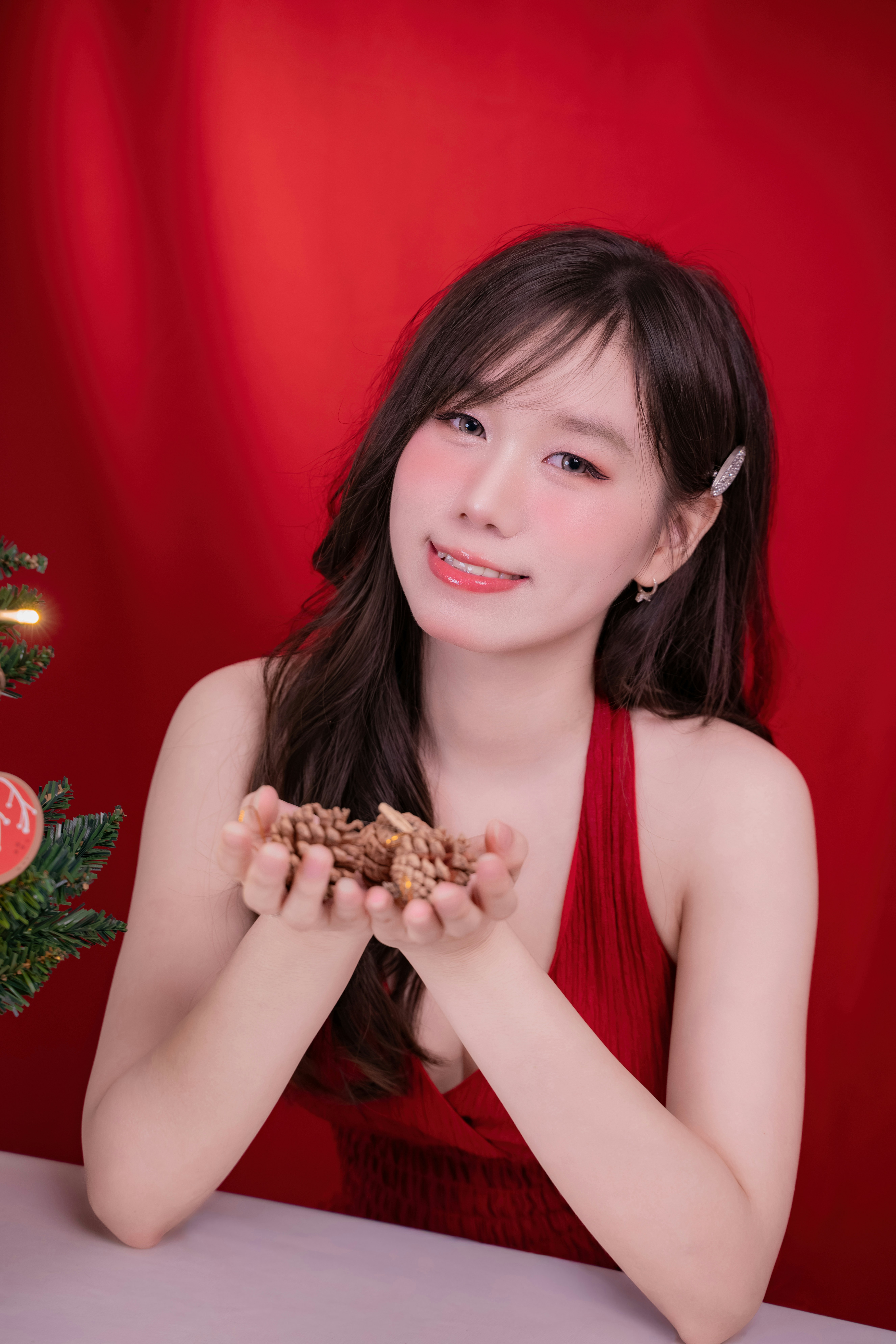 Woman holding walnuts with a red background