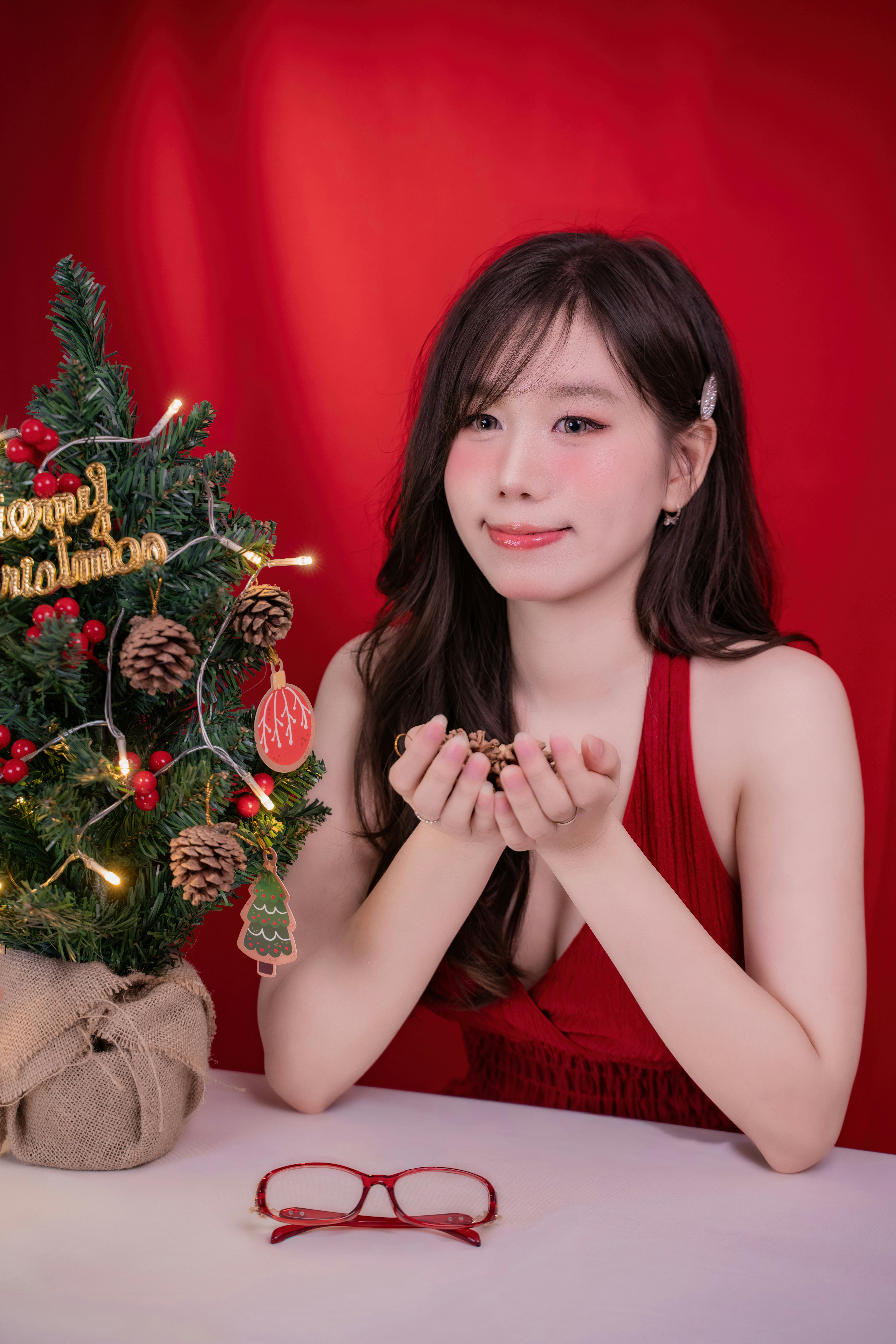 Woman in red dress with christmas tree and treats