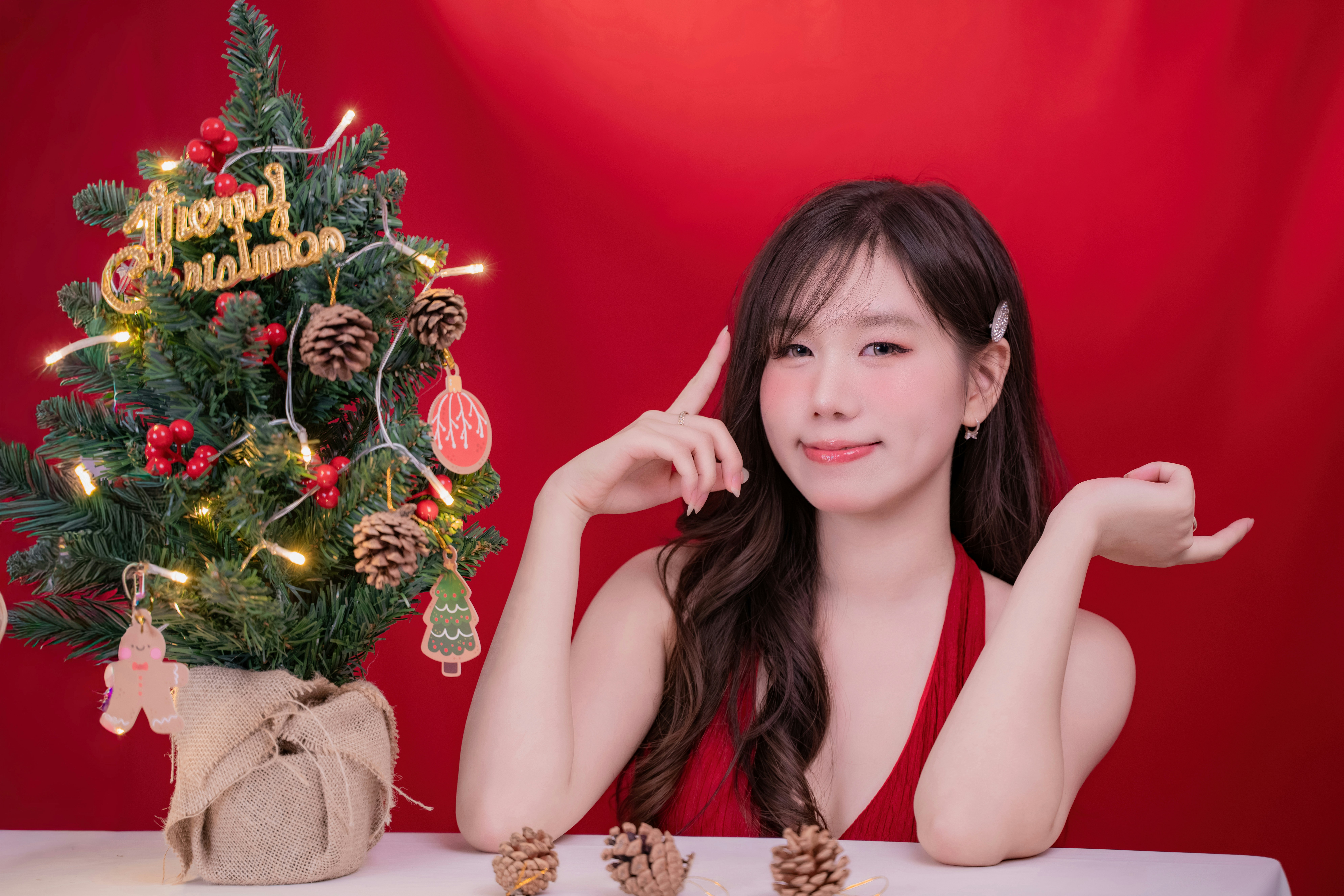 Woman in red dress with christmas tree
