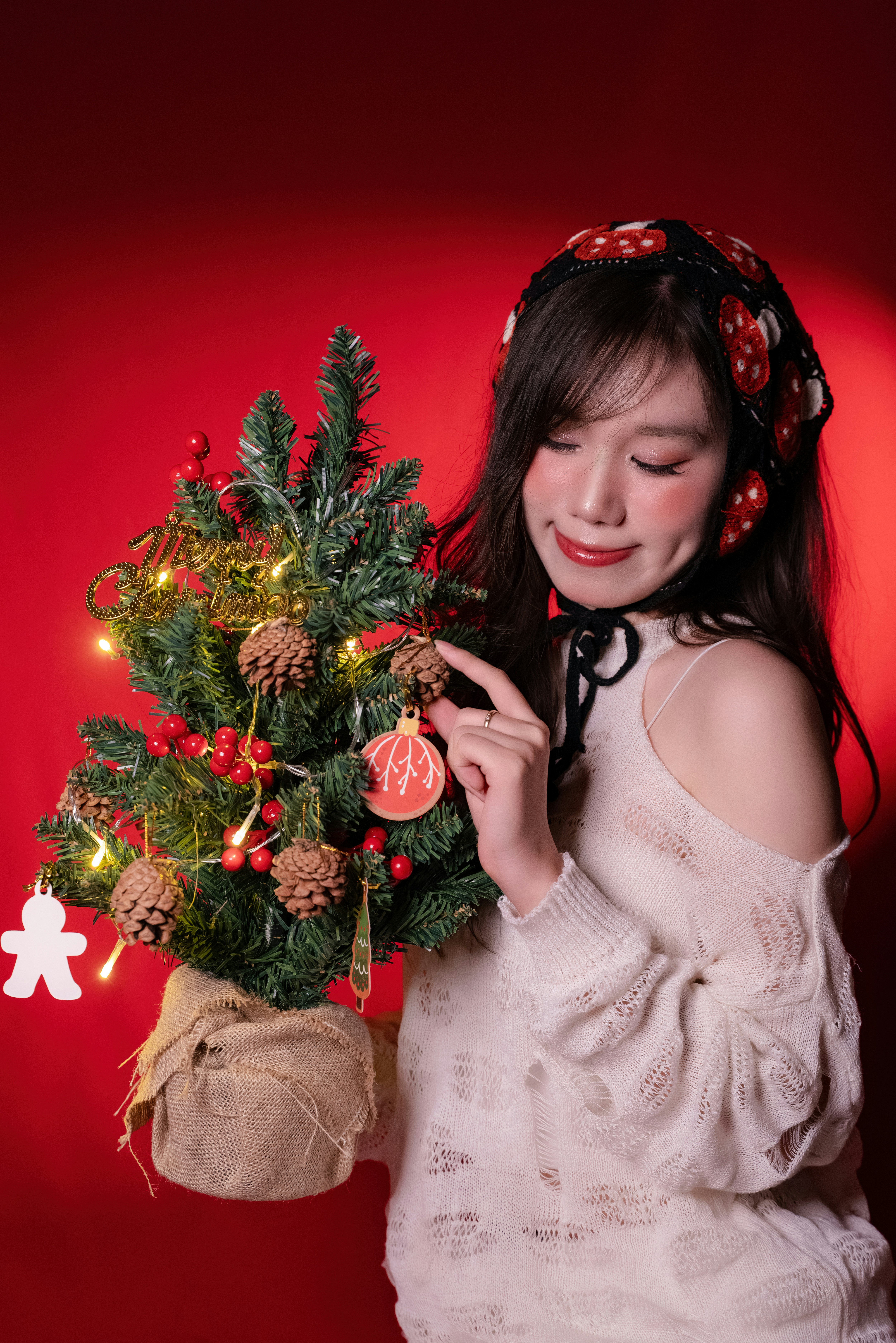 Woman decorating a small christmas tree