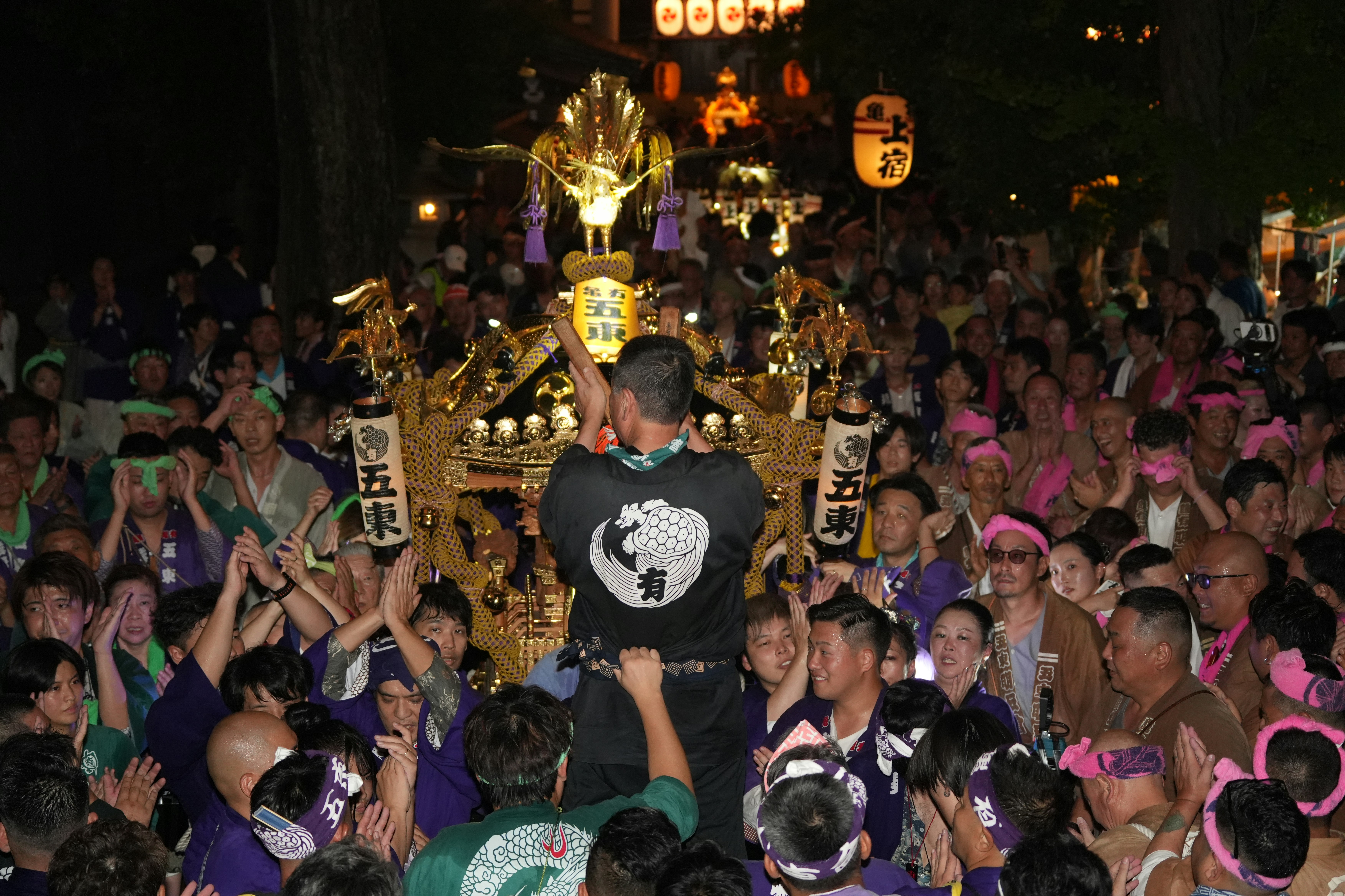 Summer night parade with colorful floats and dancers in illuminated streets