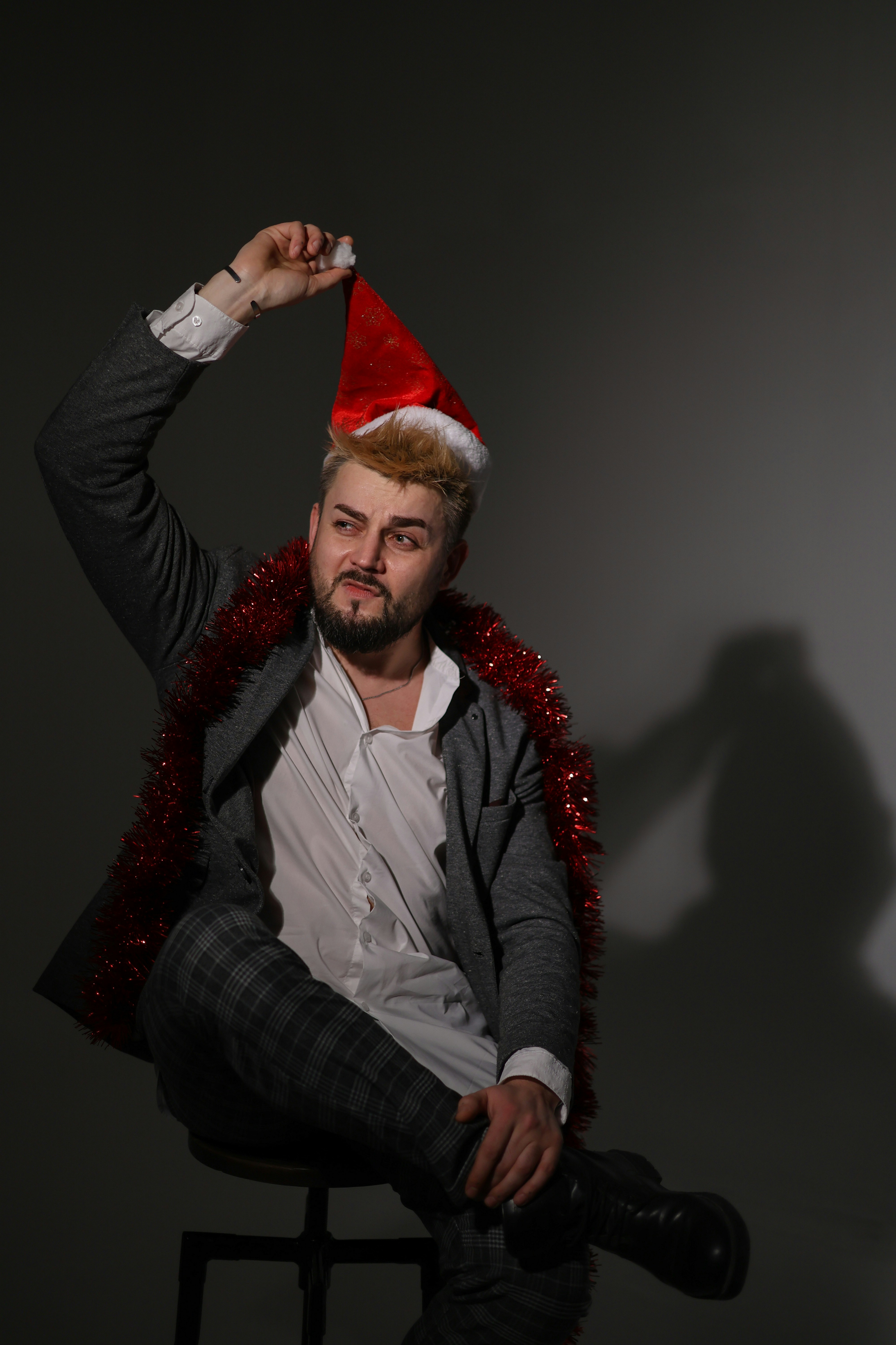 Man in santa hat with tinsel around neck