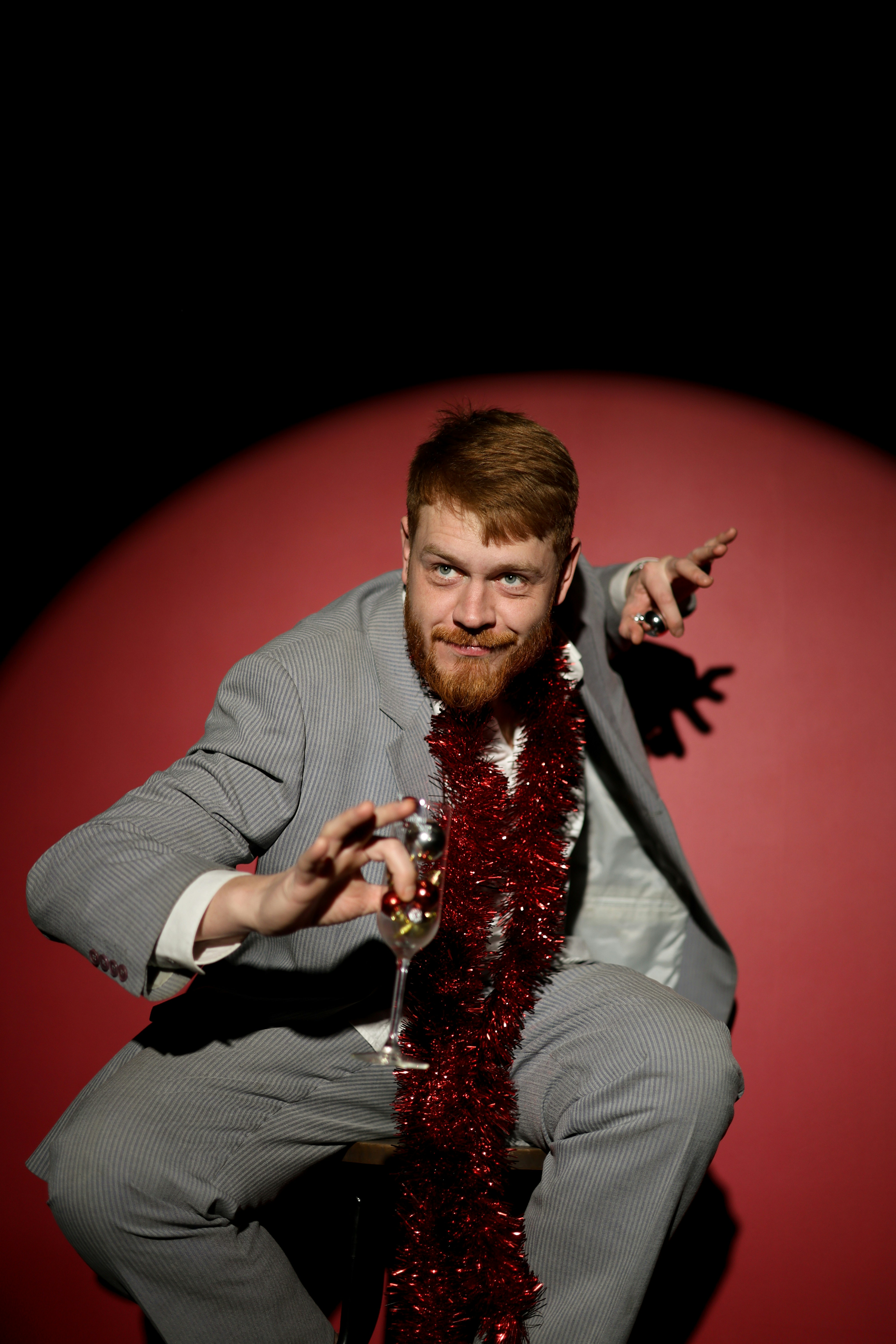 Man in suit with tinsel and champagne glass