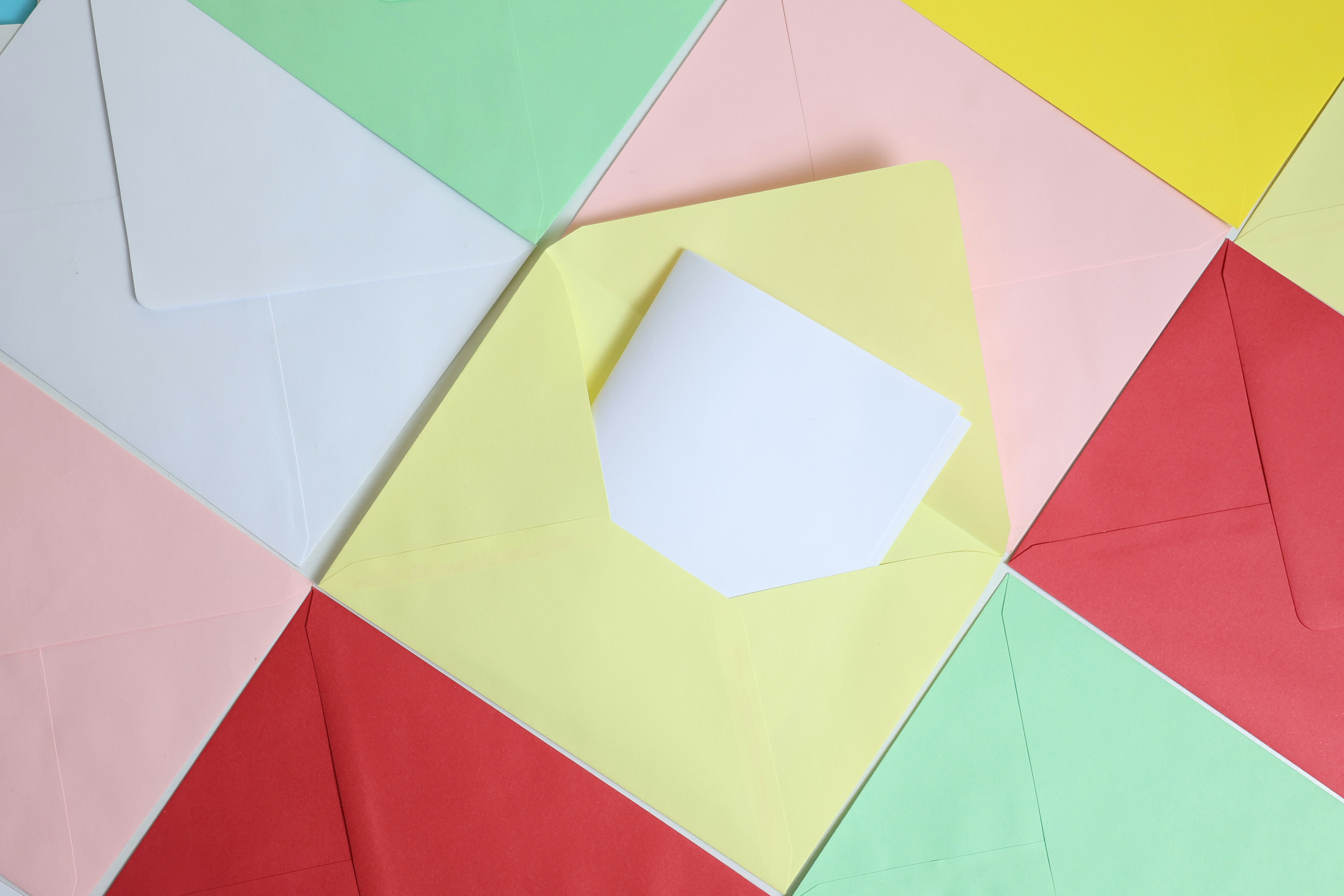 Colorful envelopes arranged in a pattern with one open