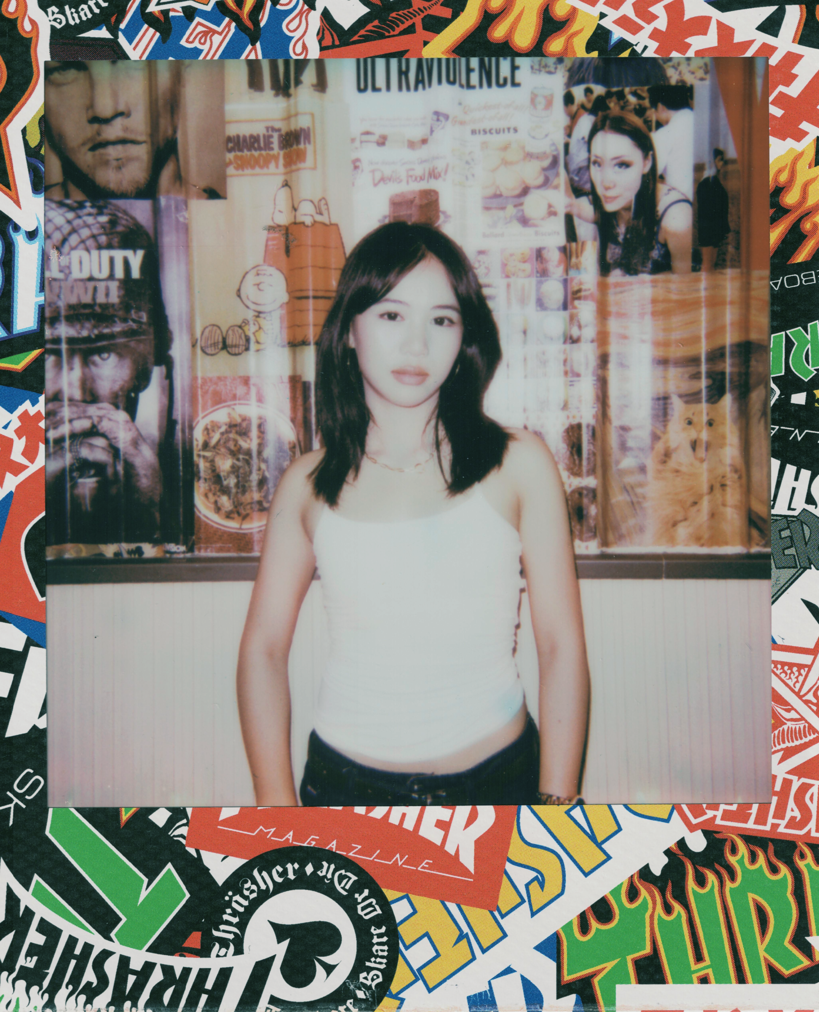 Young woman in white tank top and jeans.