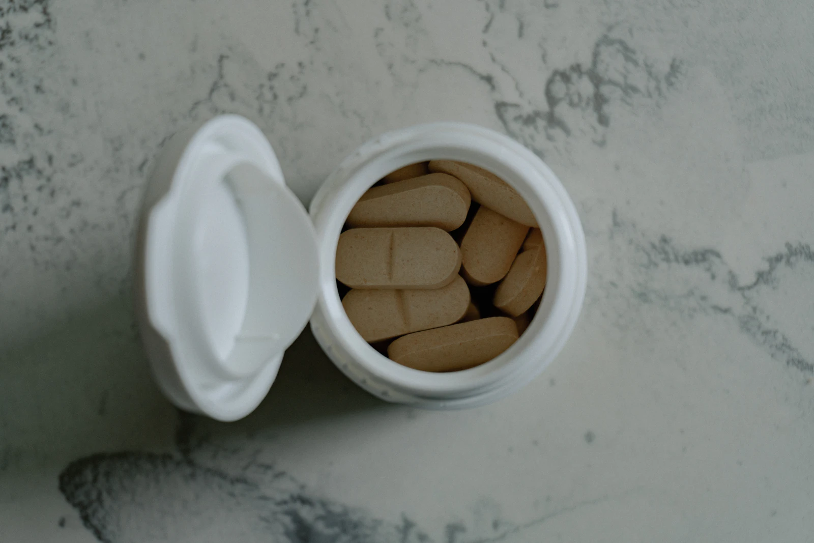 A magnesium supplement bottle with capsules on a table