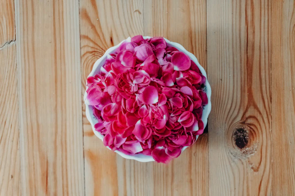 Rose petals in wooden bowl for aromatherapy