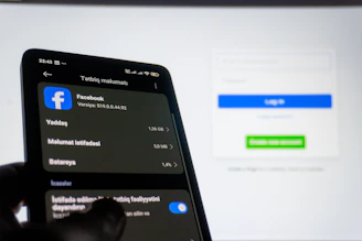 Smartphone displaying facebook settings near login screen