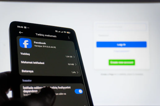Smartphone displaying facebook settings near login screen