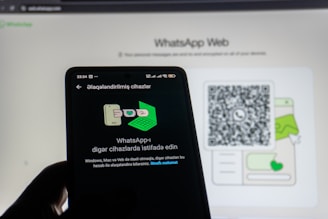 Phone scanning whatsapp web qr code on screen