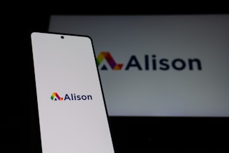 Alison logo displayed on a smartphone and screen.