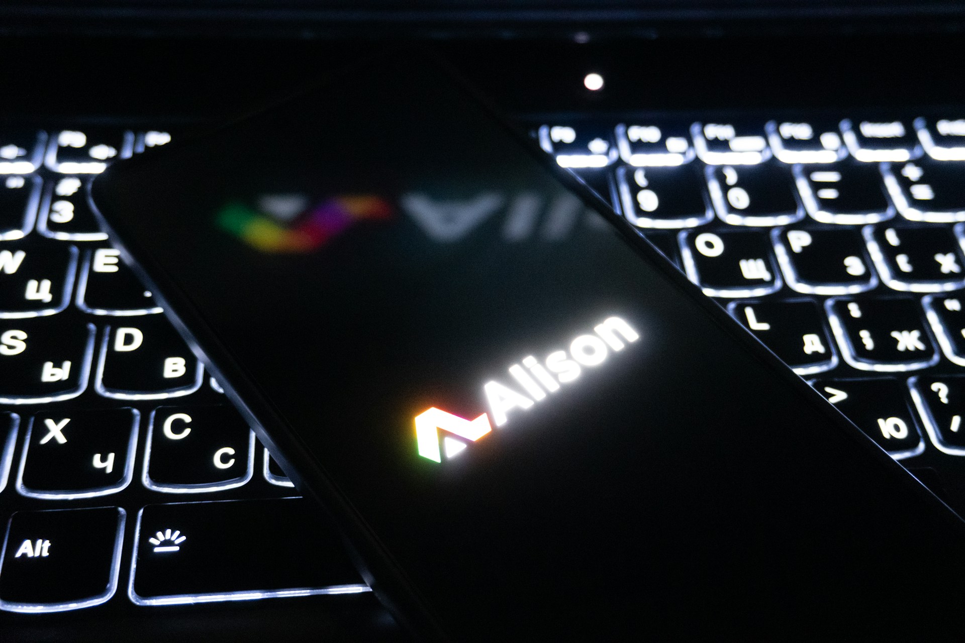 Smartphone displaying allison logo on illuminated keyboard