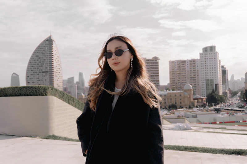 Woman in sunglasses with cityscape background