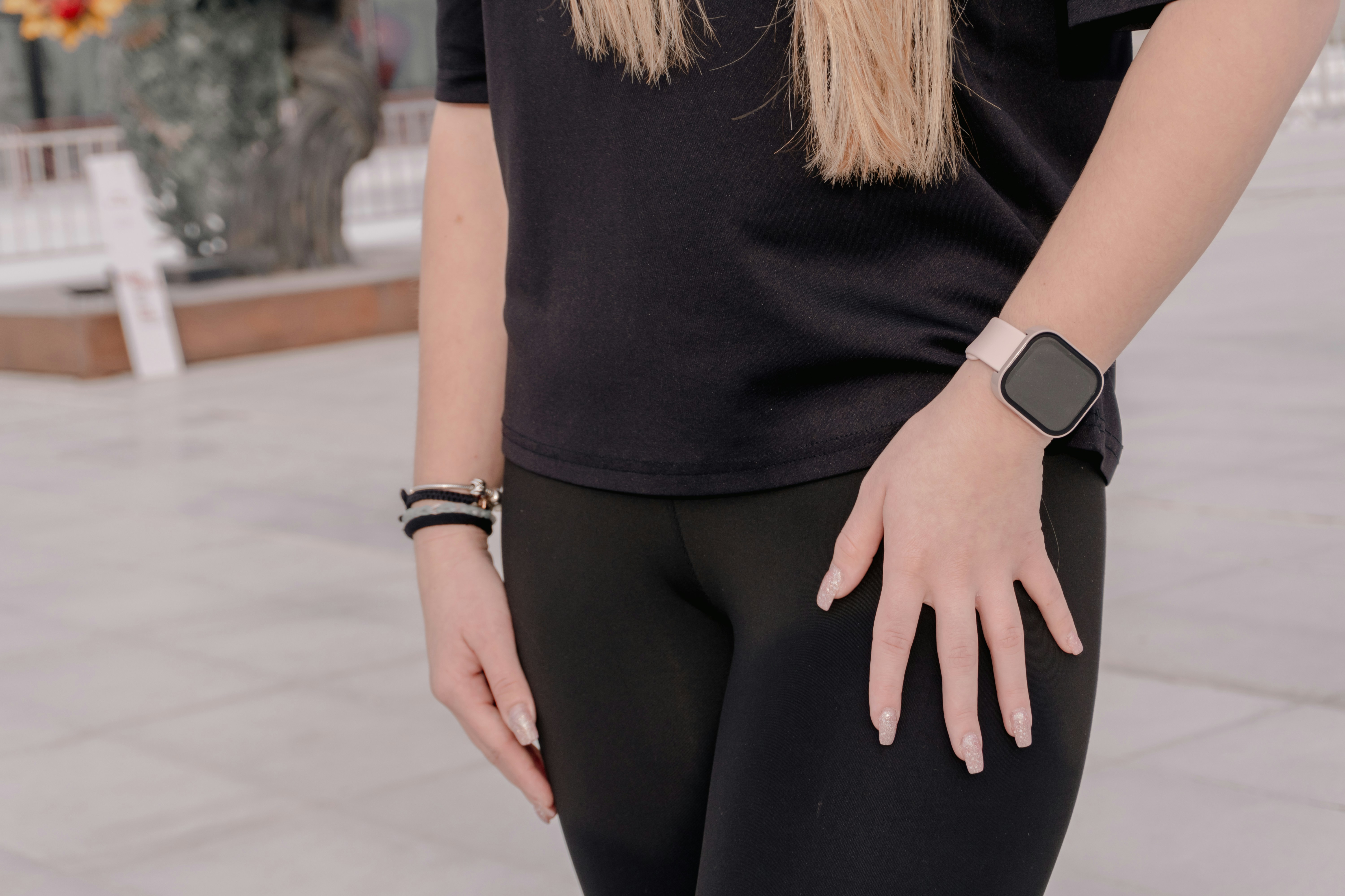 Woman in black leggings and t-shirt wearing smartwatch